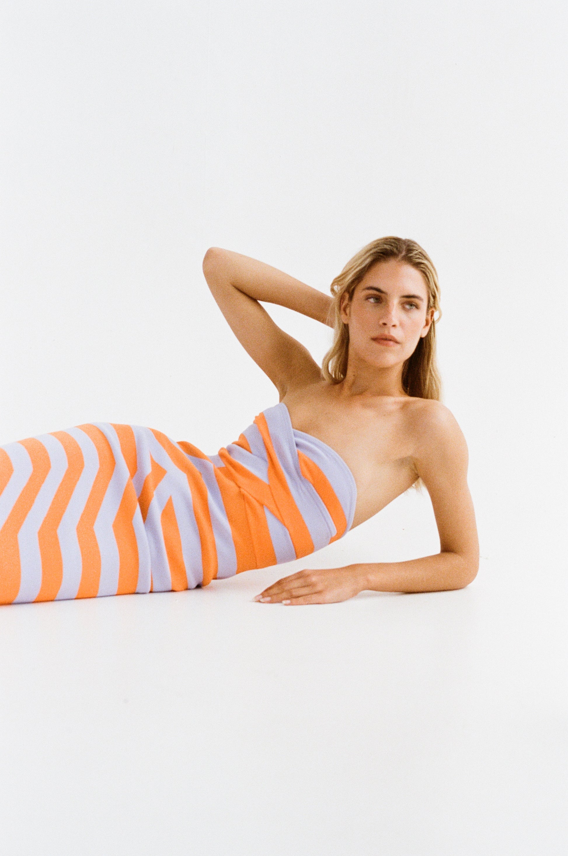 Women’s strapless Maxi Lilac Aude Dress with two-tone knit in Orange and Purple fitted silhouette gold back zip and flared hemline.