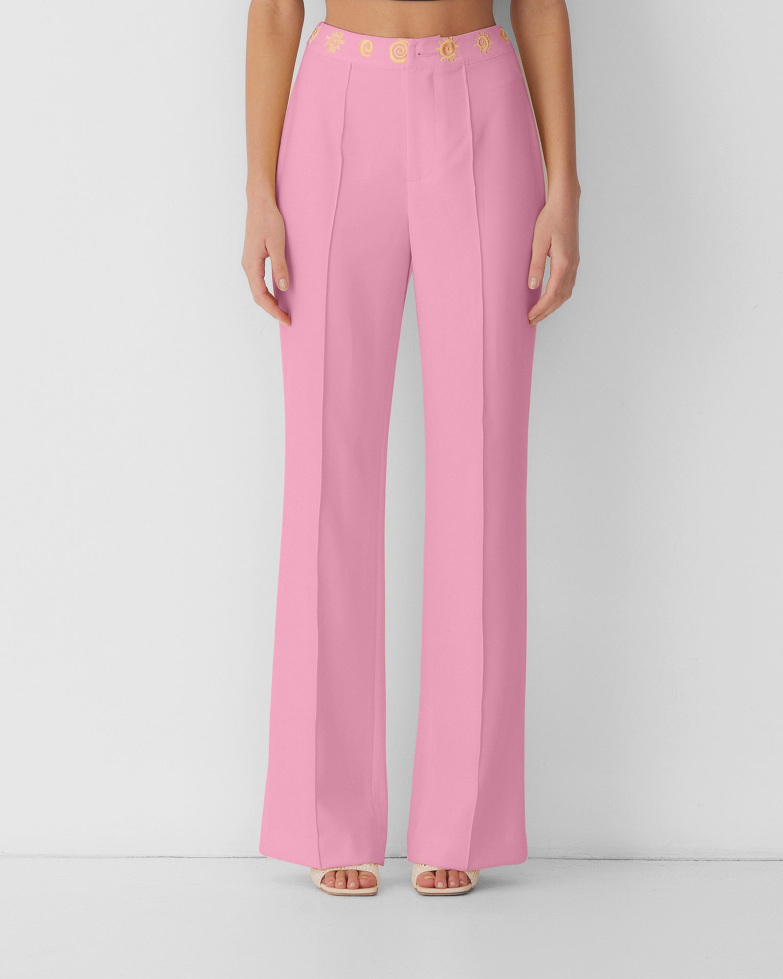 Women’s highwaisted Candy Pink Irida Bootcut Pants with pin tuck detail and embroidered waistband—wear solo or as a matching set with Irida Vest Dress.