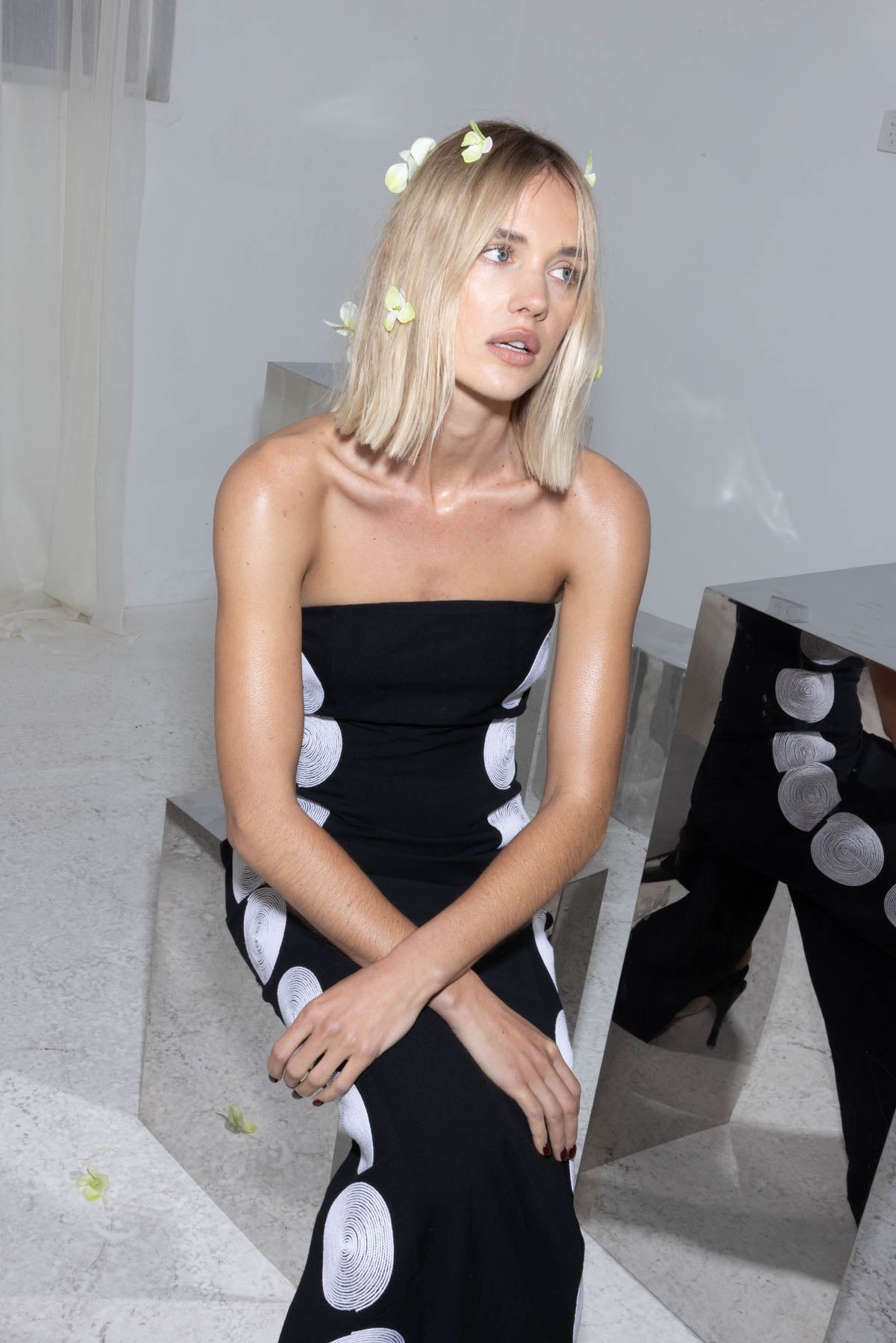 Woman wearing black linen cotton maxi dress with contrast embroidery and shaped bust.