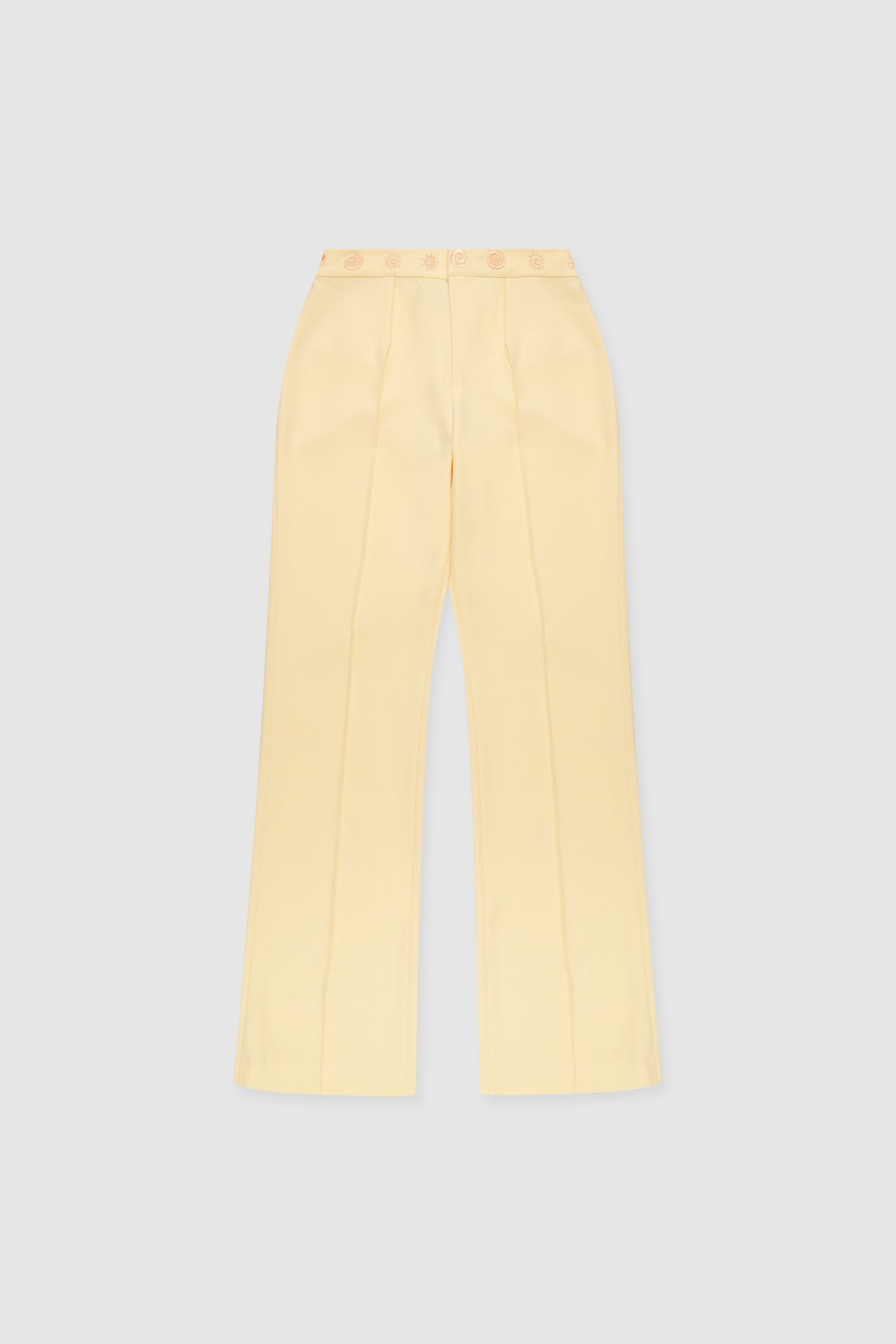 Women’s highwaisted Butter Yellow Irida Bootcut Pants with pin tuck detail and embroidered waistband—wear solo or as a matching set with Irida Vest Dress.