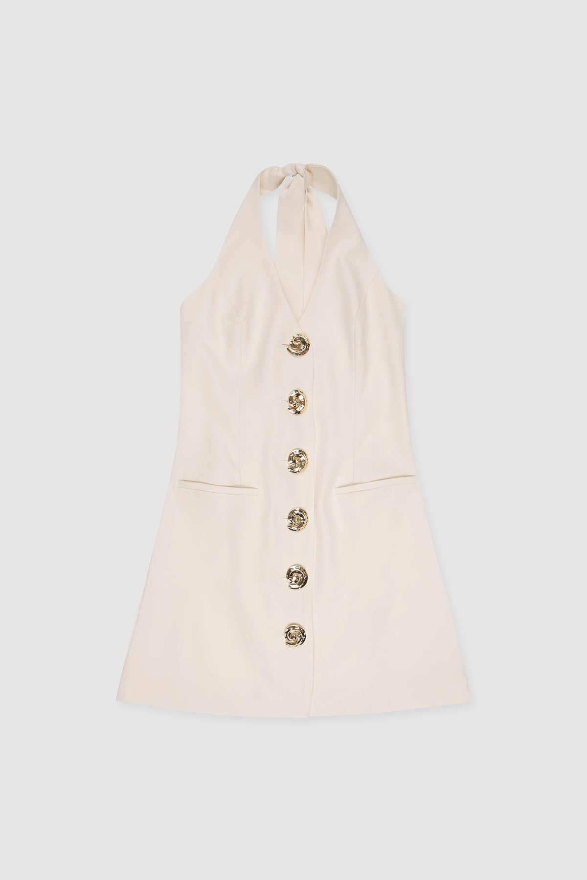 Best-selling women’s Ivory White Irida mini halter neck vest dress with gold swirl buttons, tie-back, and front welt pocket—wear alone or with matching pants. Perfect for Brides.