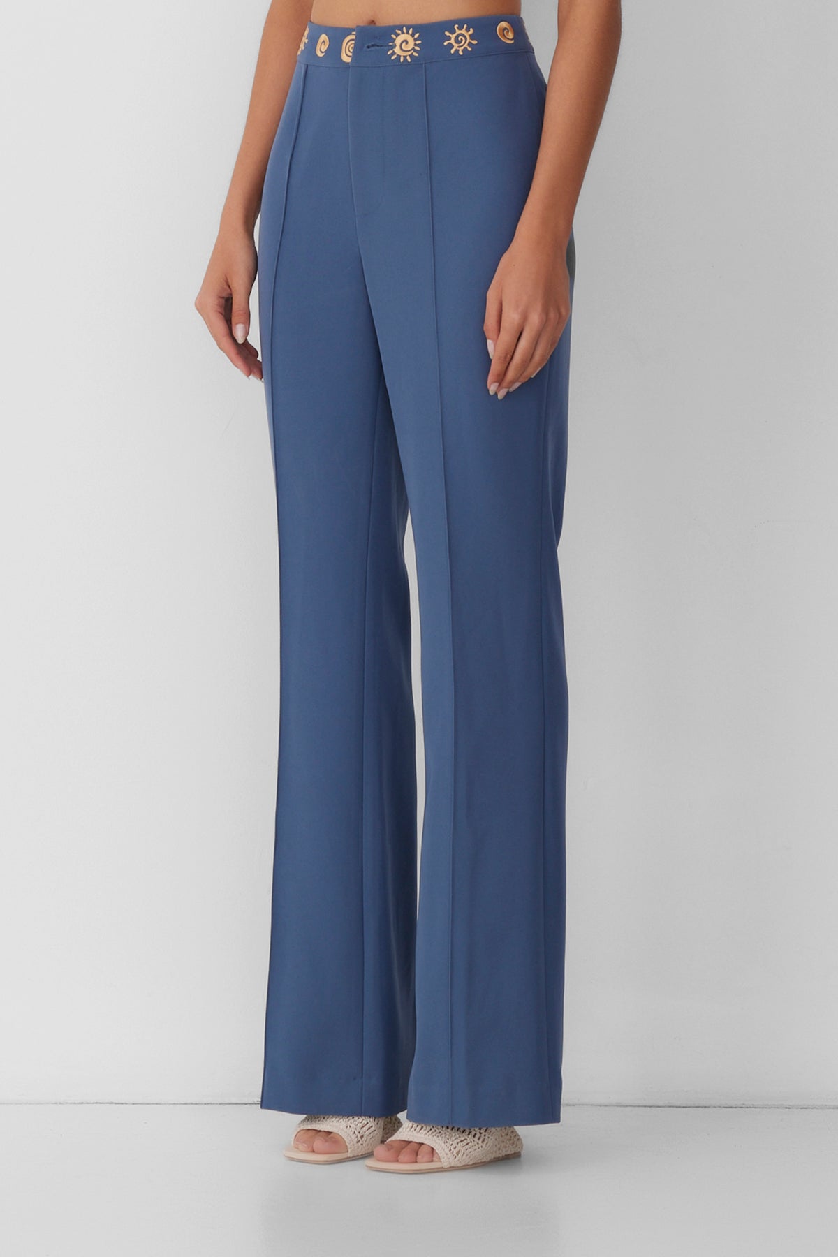 Women’s highwaisted Navy Blue Stone Irida Bootcut Pants with pin tuck detail and embroidered waistband—wear solo or as a matching set with Irida Vest Dress.