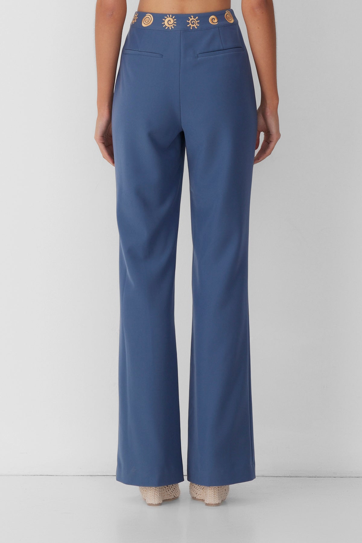 Women’s highwaisted Navy Blue Stone Irida Bootcut Pants with pin tuck detail and embroidered waistband—wear solo or as a matching set with Irida Vest Dress.