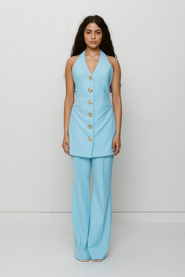 Women’s highwaisted Sky Blue Irida Bootcut Pants with pin tuck detail and embroidered waistband—wear solo or as a matching set with Irida Vest Dress.