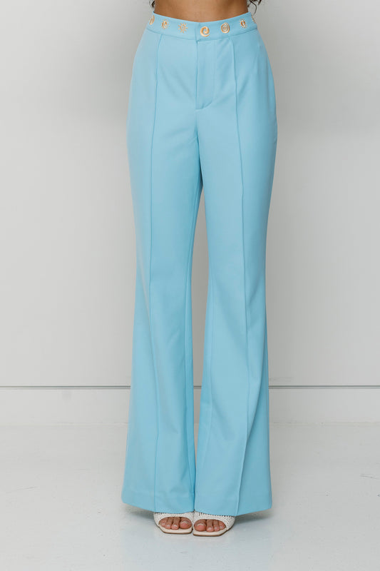 Women’s highwaisted Sky Blue Irida Bootcut Pants with pin tuck detail and embroidered waistband—wear solo or as a matching set with Irida Vest Dress.
