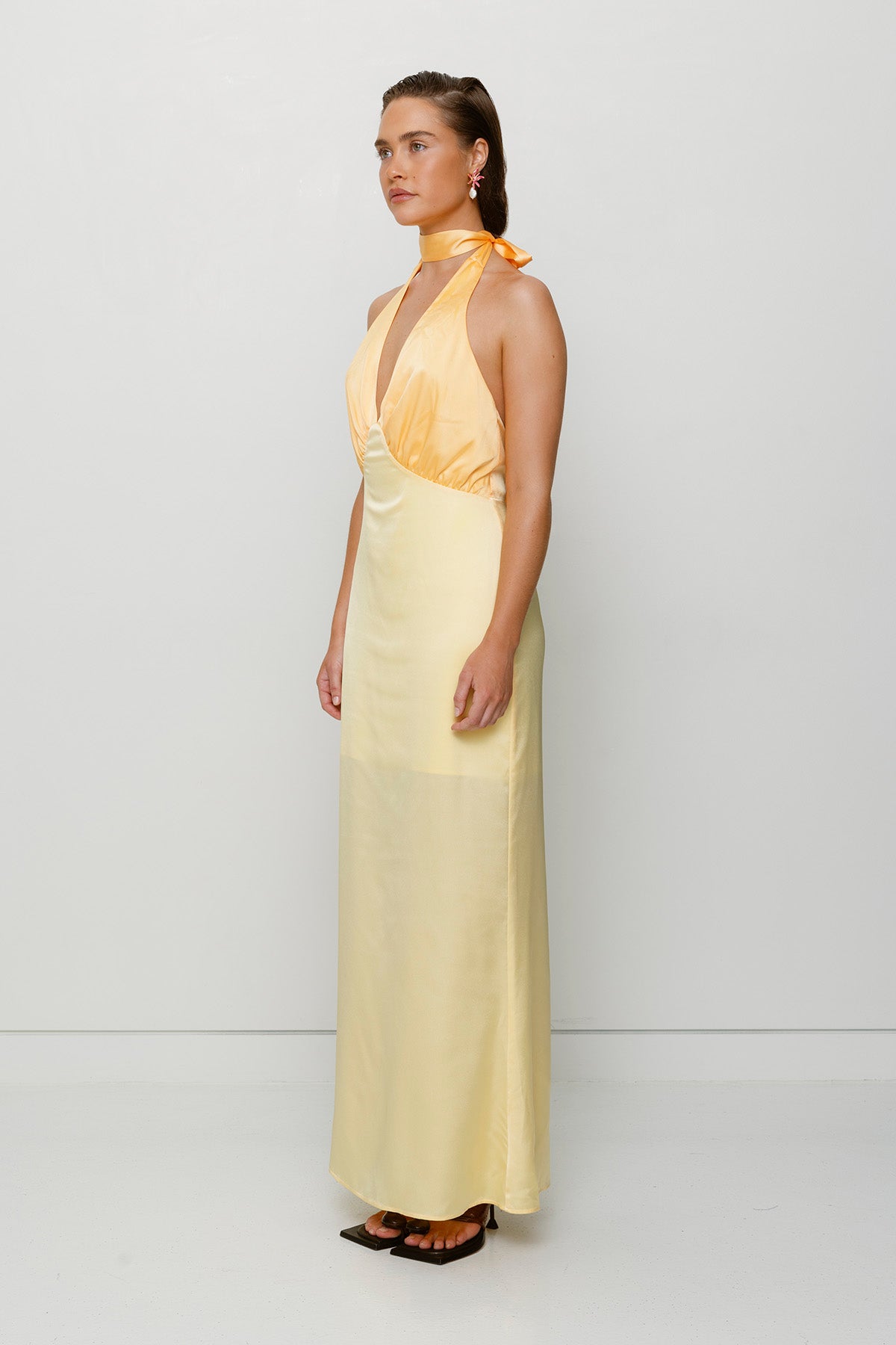 Elegant yellow satin bridesmaid slip dress with adjustable tie neck and contrast bodice.