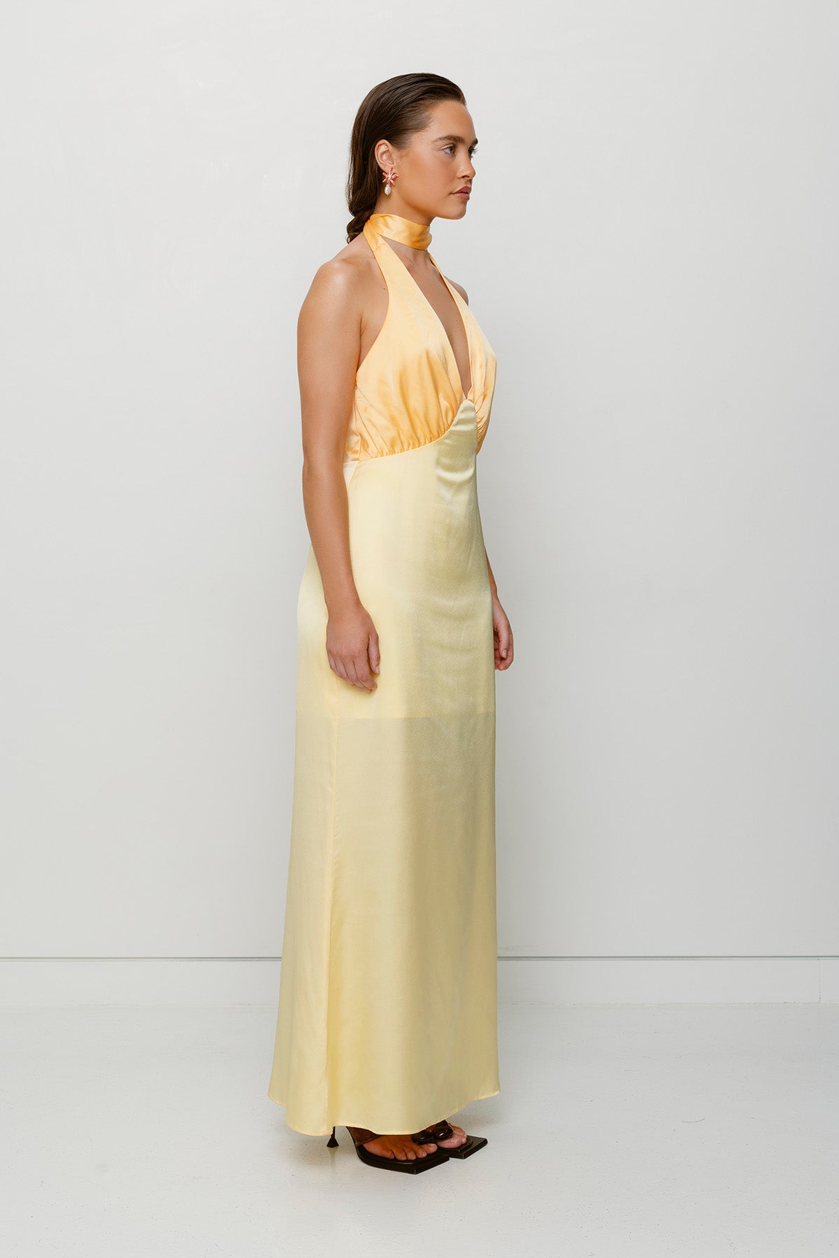 Elegant yellow satin bridesmaid slip dress with adjustable tie neck and contrast bodice.