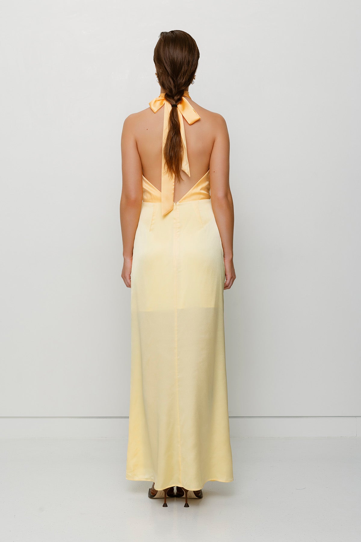 Elegant yellow satin bridesmaid slip dress with adjustable tie neck and contrast bodice.