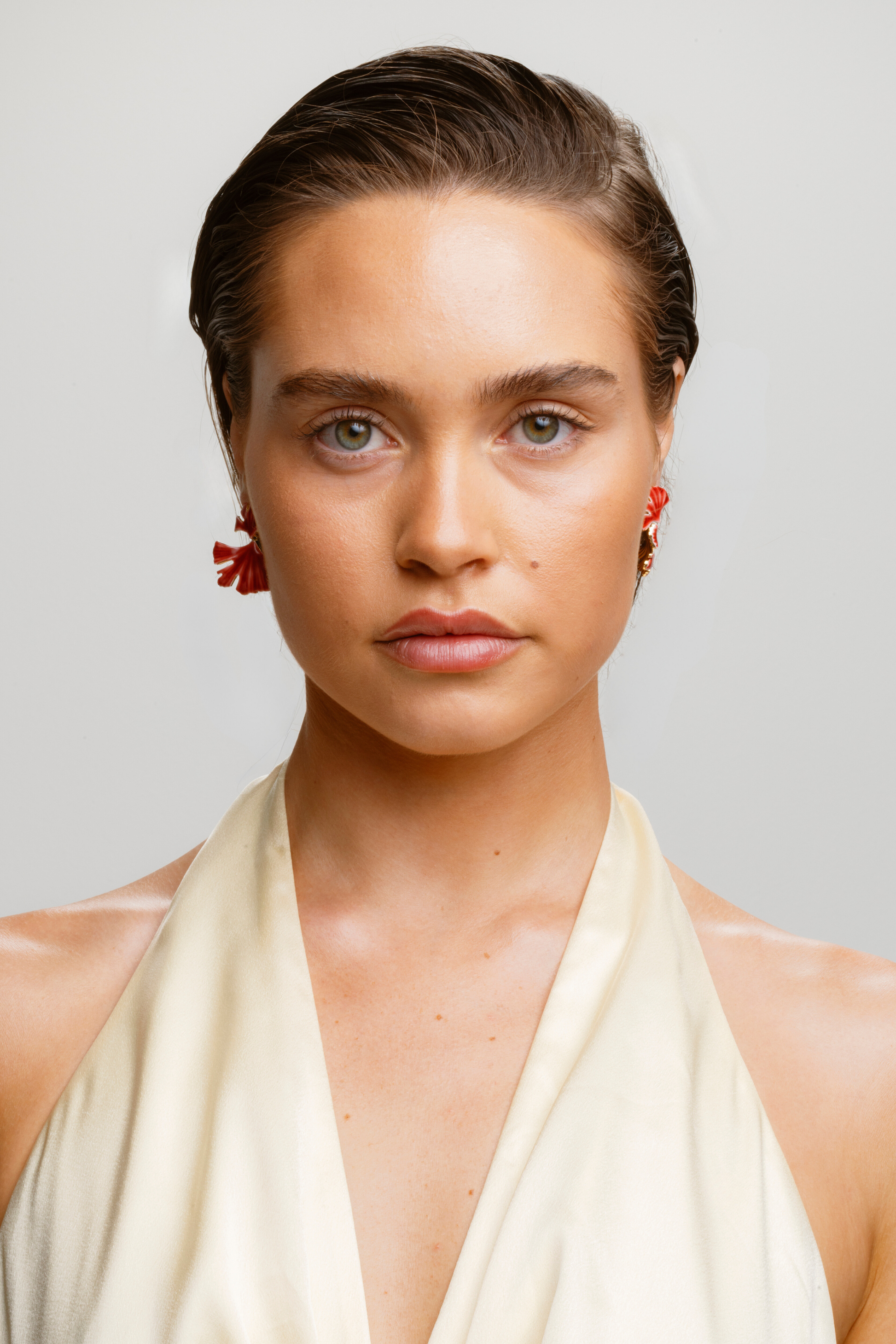 Red stud earrings with gold-sprayed sterling silver hardware, perfect for gifting.