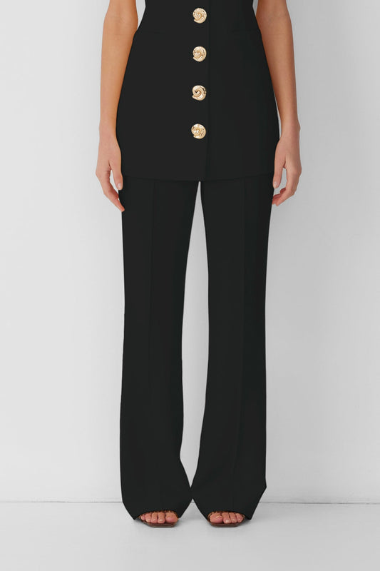 Women’s highwaisted Black Noir Irida Bootcut Pants with pin tuck detail and embroidered waistband—wear solo or as a matching set with Irida Vest Dress.