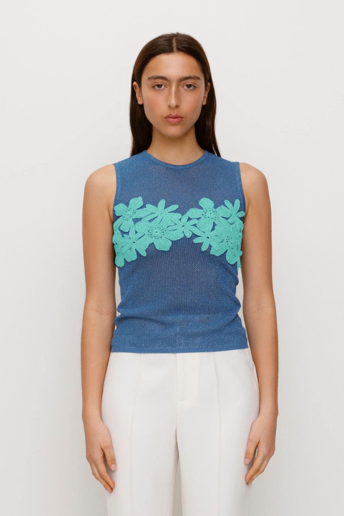 Blue stretchy knit top with 3D hand-crochet floral details and metallic lurex finish.