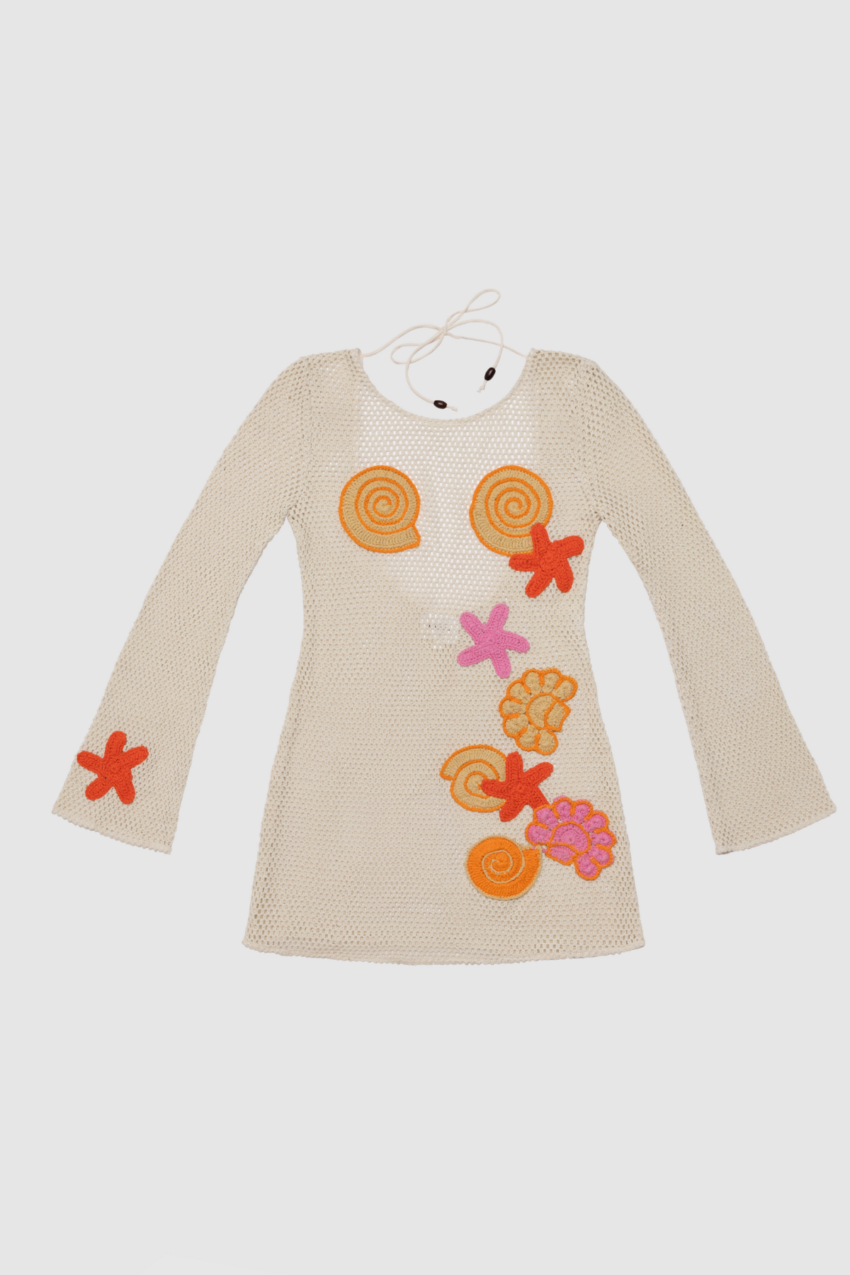 Women’s Creme Enza Mini Dress with handmade sea-themed crochet motifs, detachable slip lining, bell-shaped long sleeves, and bright prints.