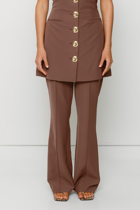 Women’s highwaisted Chocolate Brown Irida Bootcut Pants with pin tuck detail and embroidered waistband—wear solo or as a matching set with Irida Vest Dress.