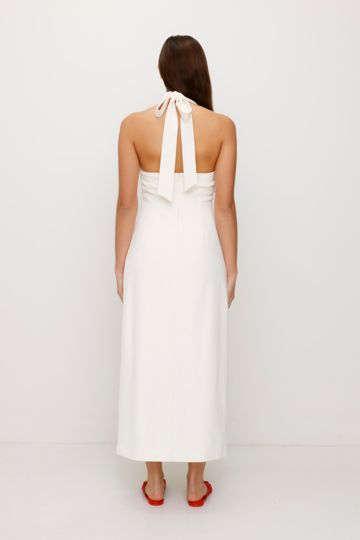 Women’s fitted maxi vest style dress in Ivory White with halter neck tie back gold swirl detailing and invisible back zip for a flattering fit and perfect for brides.