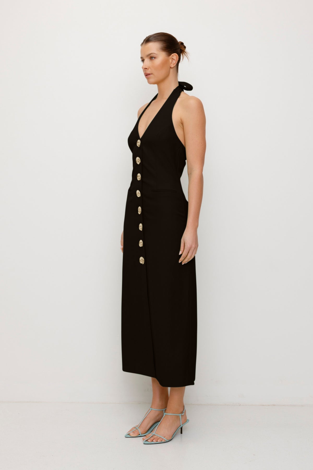 Women’s fitted maxi vest style dress in Noir Black with halter neck tie back gold swirl detailing and invisible back zip for a flattering fit