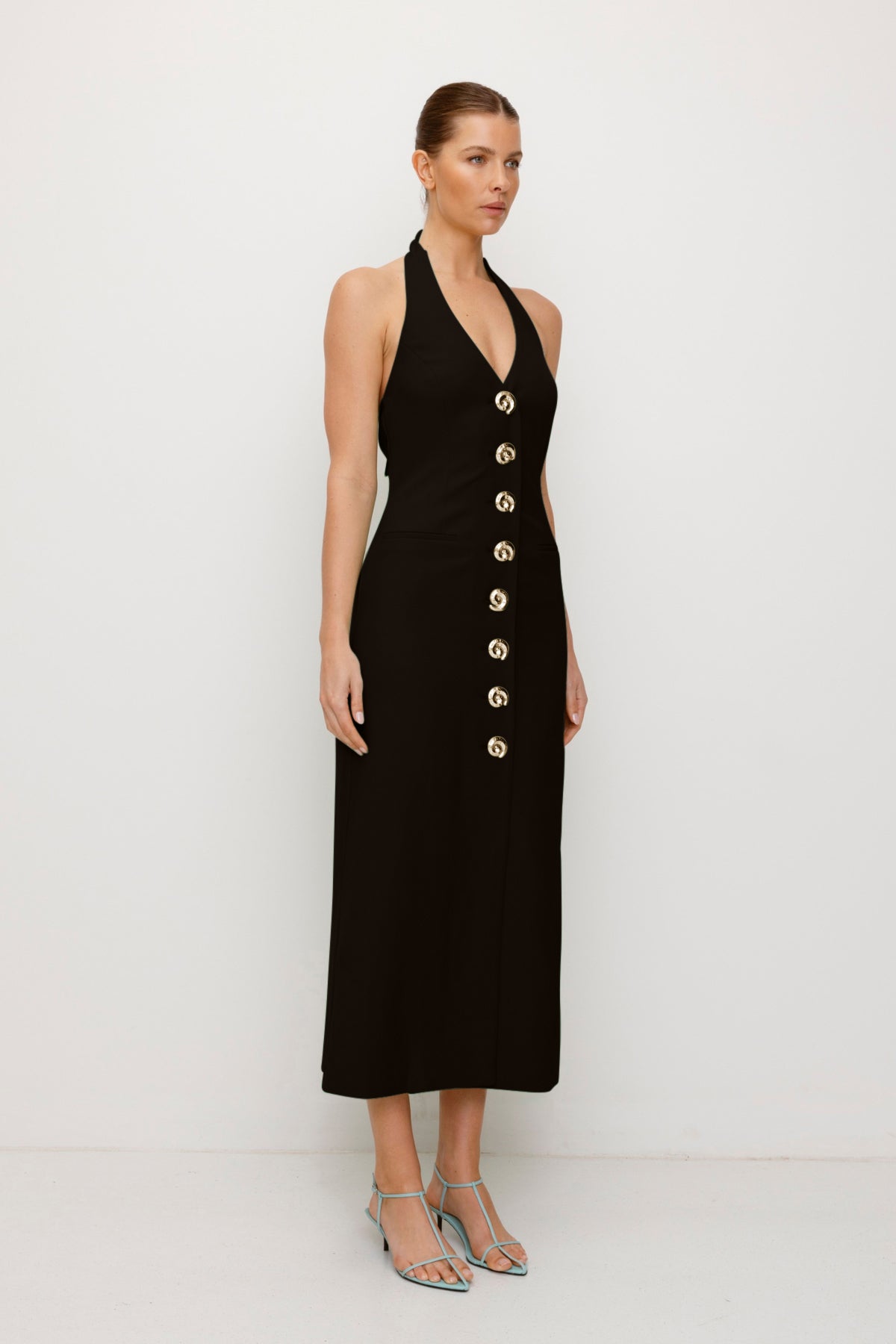 Women’s fitted maxi vest style dress in Noir Black with halter neck tie back gold swirl detailing and invisible back zip for a flattering fit