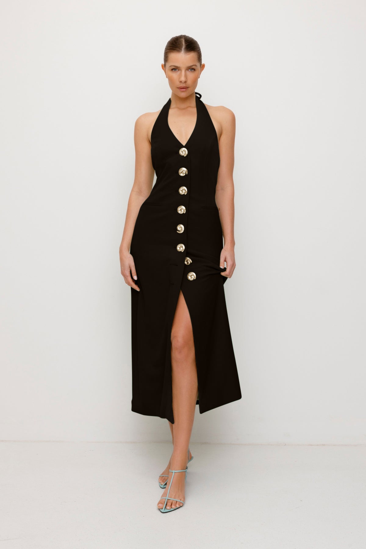 Women’s fitted maxi vest style dress in Noir Black with halter neck tie back gold swirl detailing and invisible back zip for a flattering fit