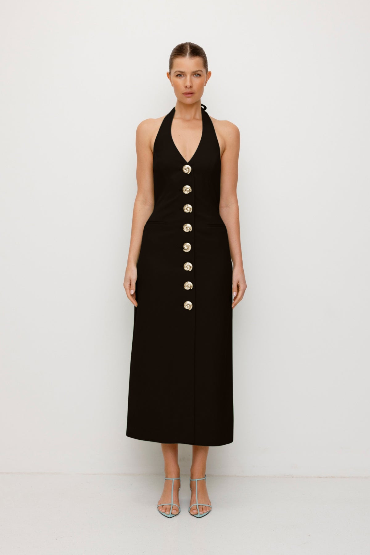 Women’s fitted maxi vest style dress in Noir Black with halter neck tie back gold swirl detailing and invisible back zip for a flattering fit