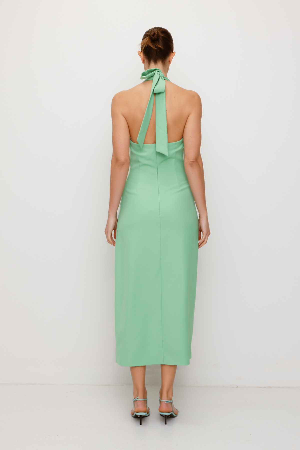 Women’s fitted maxi vest style dress in Sage Green with halter neck tie back gold swirl detailing and invisible back zip for a flattering fit.
