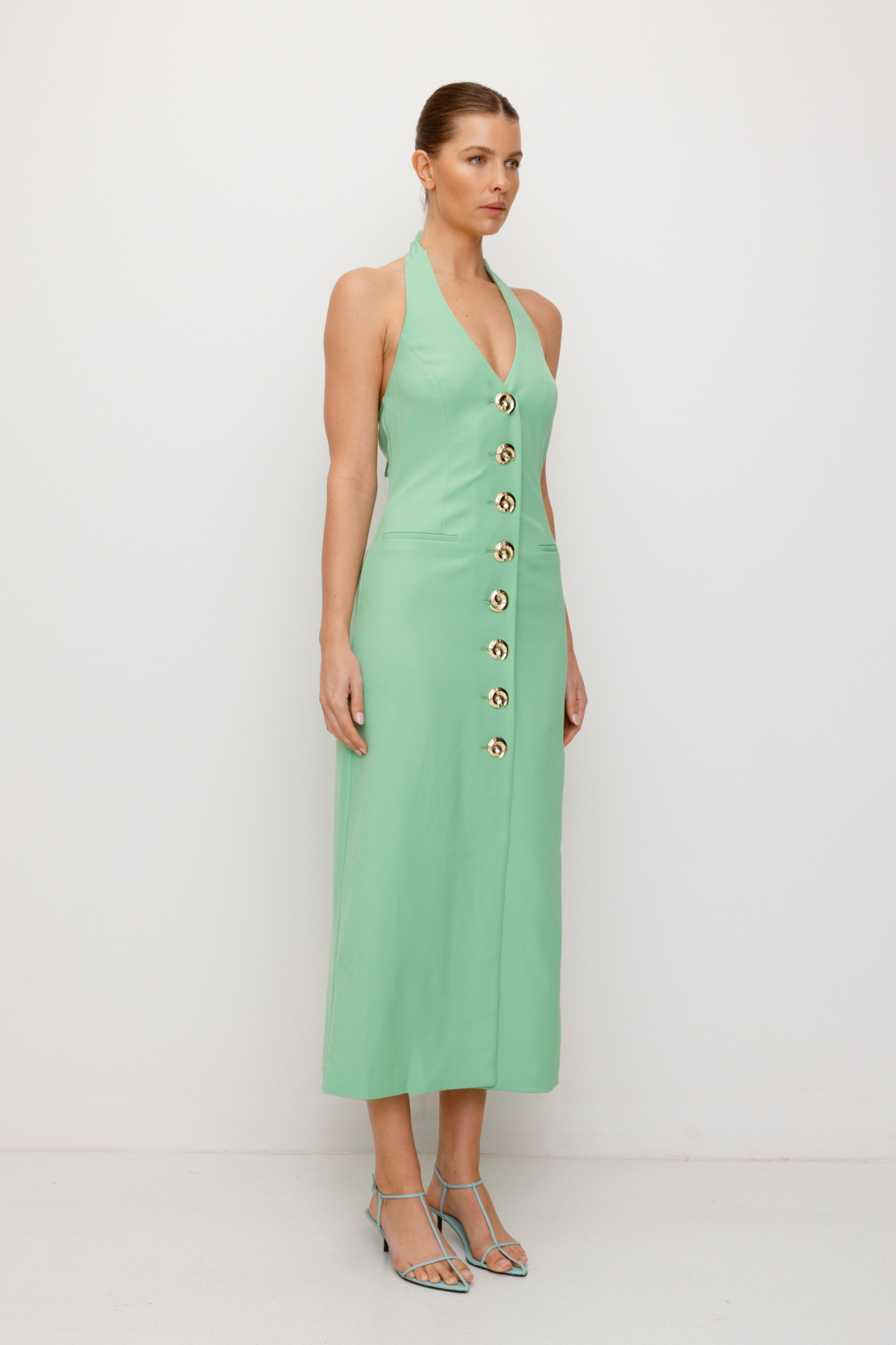 Women’s fitted maxi vest style dress in Sage Green with halter neck tie back gold swirl detailing and invisible back zip for a flattering fit.