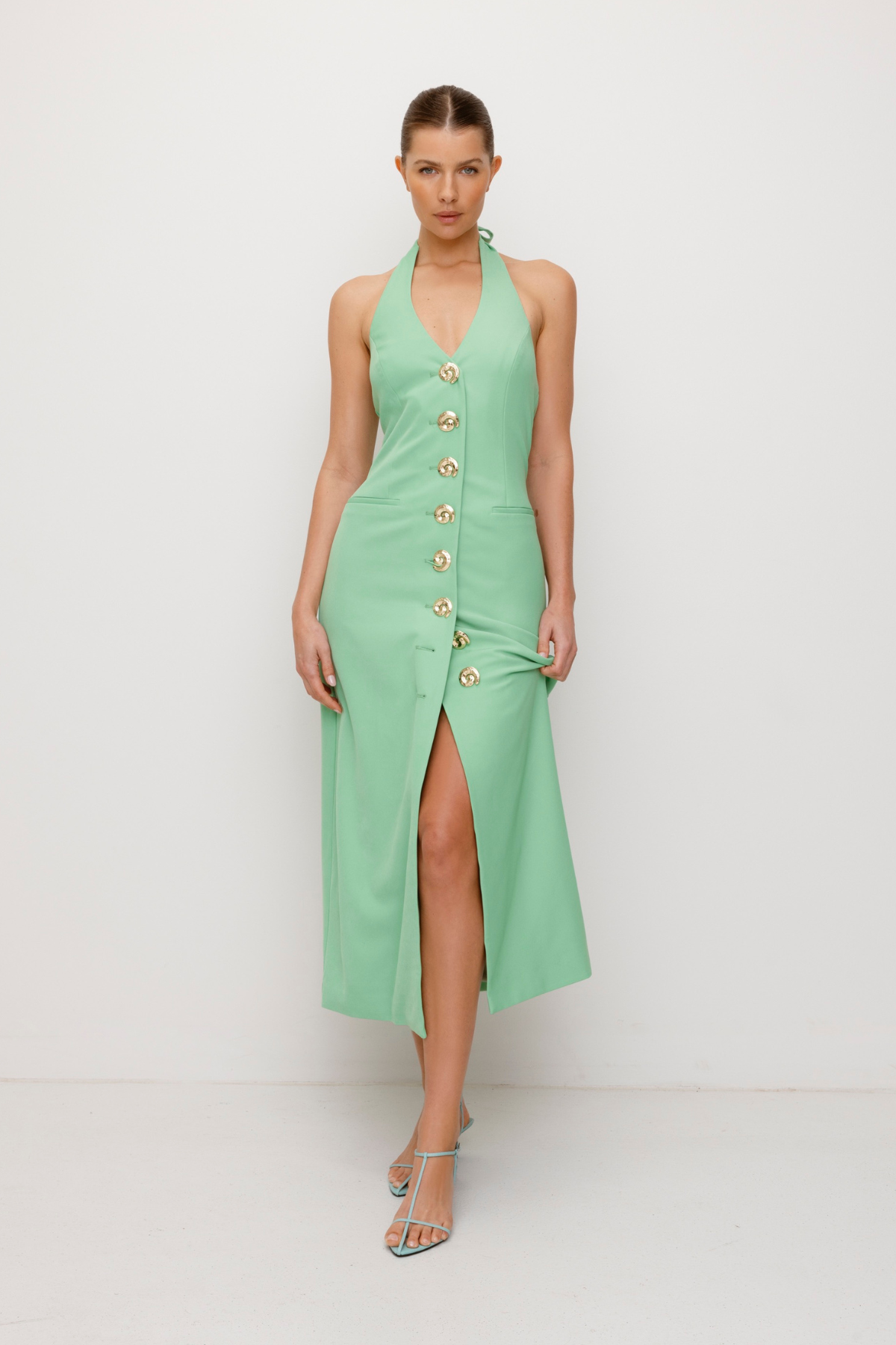 Women’s fitted maxi vest style dress in Sage Green with halter neck tie back gold swirl detailing and invisible back zip for a flattering fit.