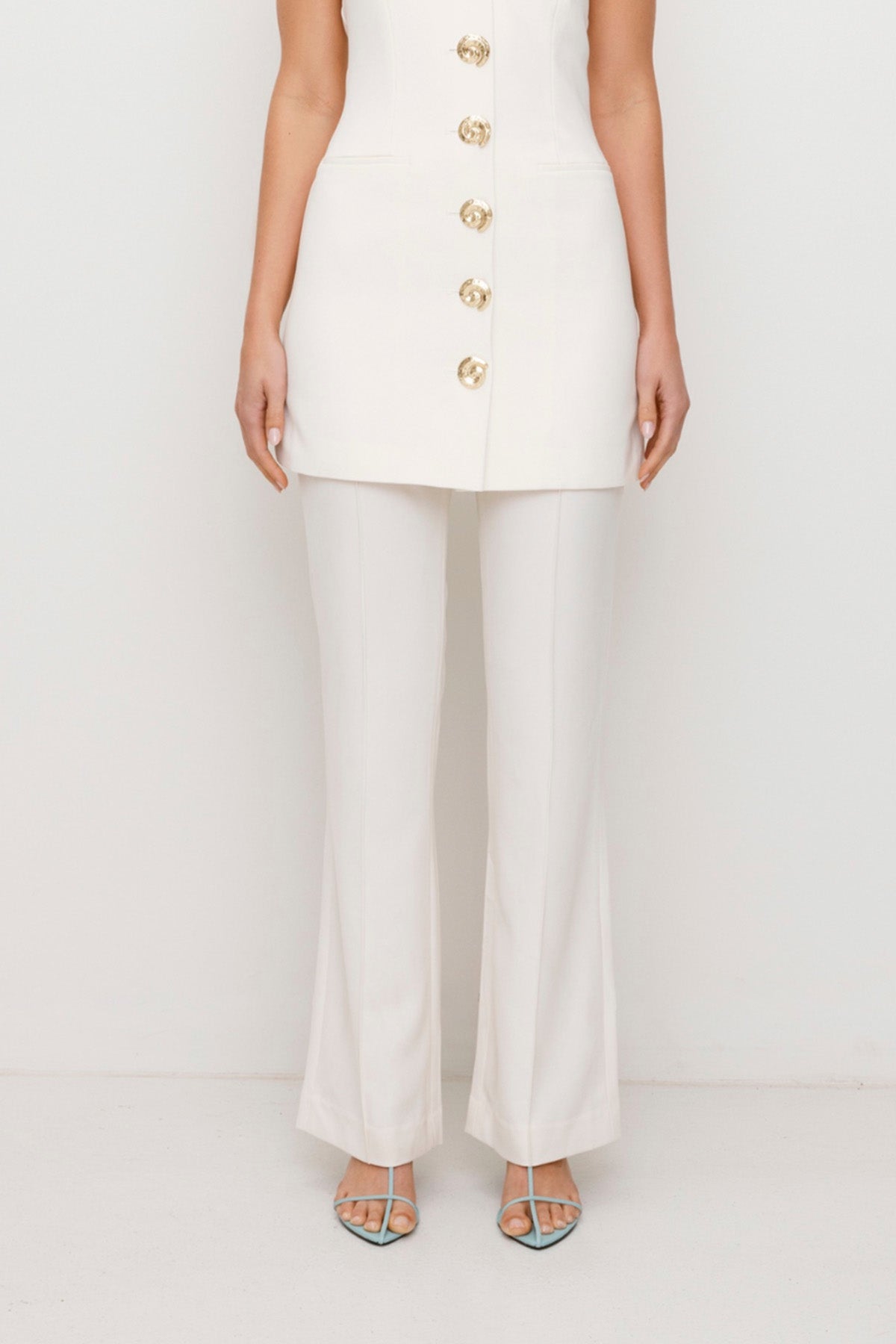 Women’s highwaisted Ivory White Irida Bootcut Pants perfect for brides with pin tuck detail and embroidered waistband—wear solo or as a matching set with Irida Vest Dress.