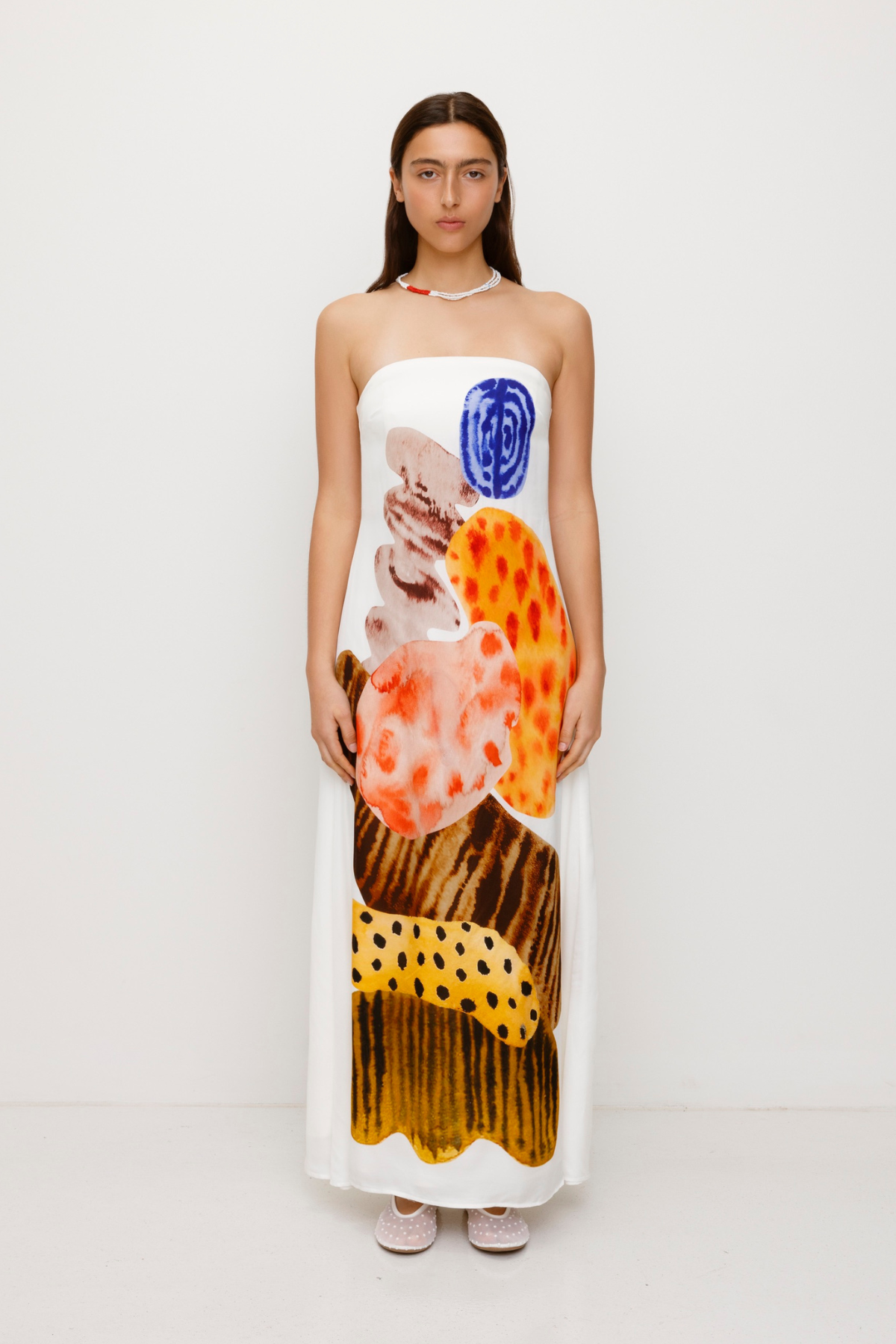 Women’s strapless White Kora Maxi Dress with asymmetric cowl neckline, abstract print, and invisible zip—perfect for events or long lunches.