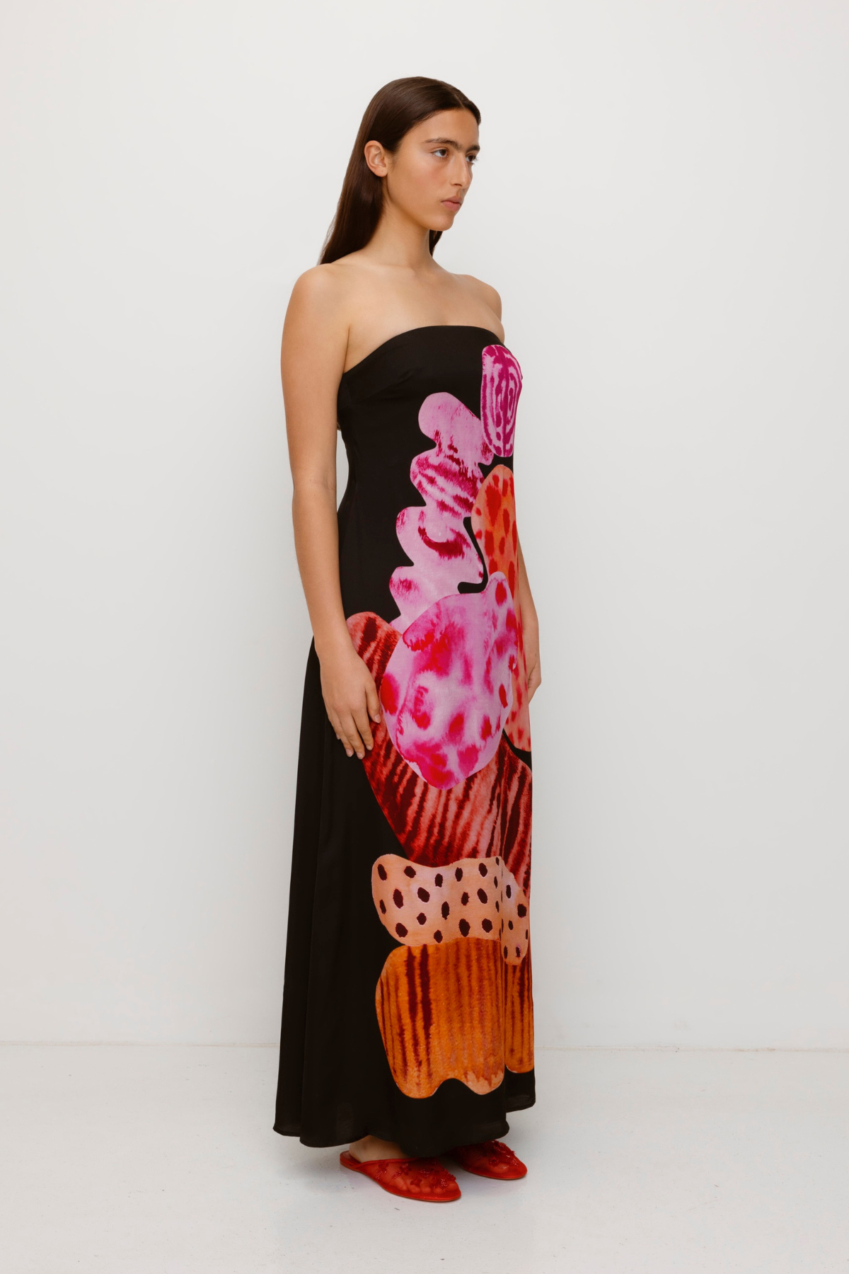 Women’s strapless Black Noir Kora Maxi Dress with asymmetric cowl neckline, abstract print, and invisible zip—perfect for events or long lunches.