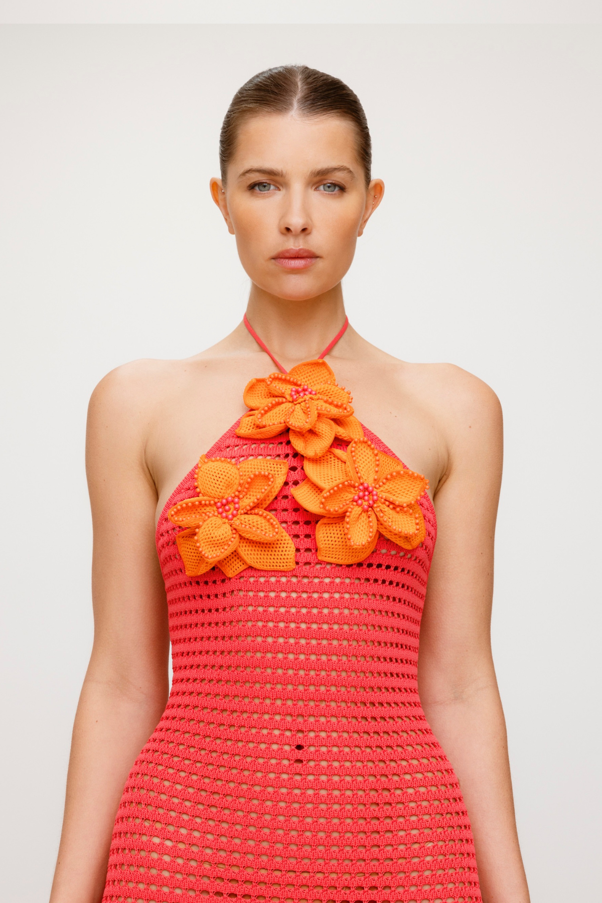 Bright halterneck knit maxi dress with 3D beaded crochet flowers and body-hugging fit.