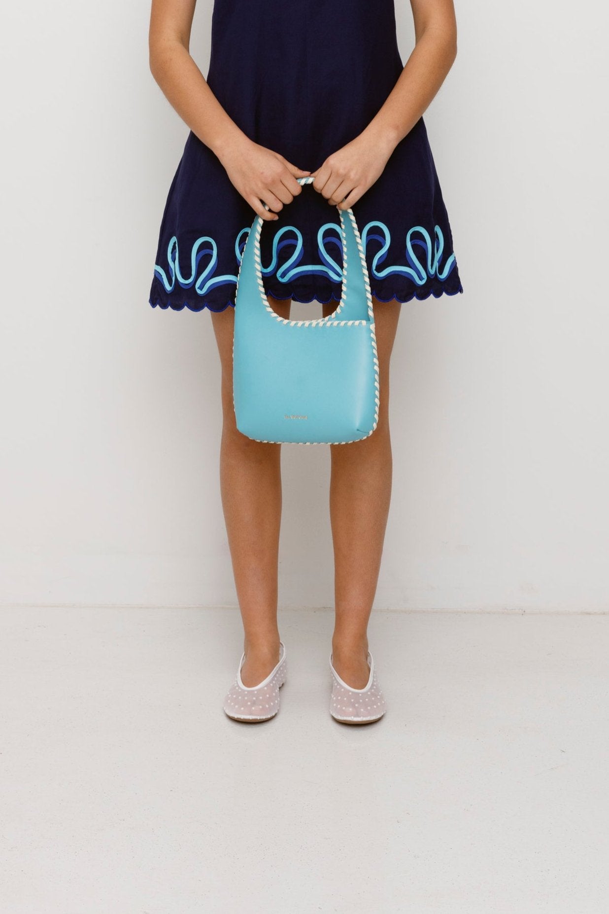 Women’s Aqua Blue Mara Shoulder Bag in 100 percent leather with twisted strap contrast binding and magnetic snap closure for everyday wear.