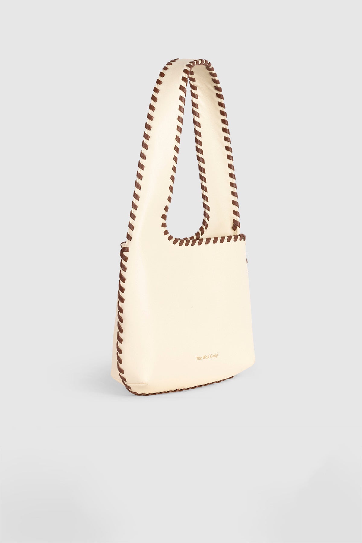 Women’s Cream Mara Shoulder Bag in 100 percent leather with twisted strap contrast binding and magnetic snap closure for everyday wear.