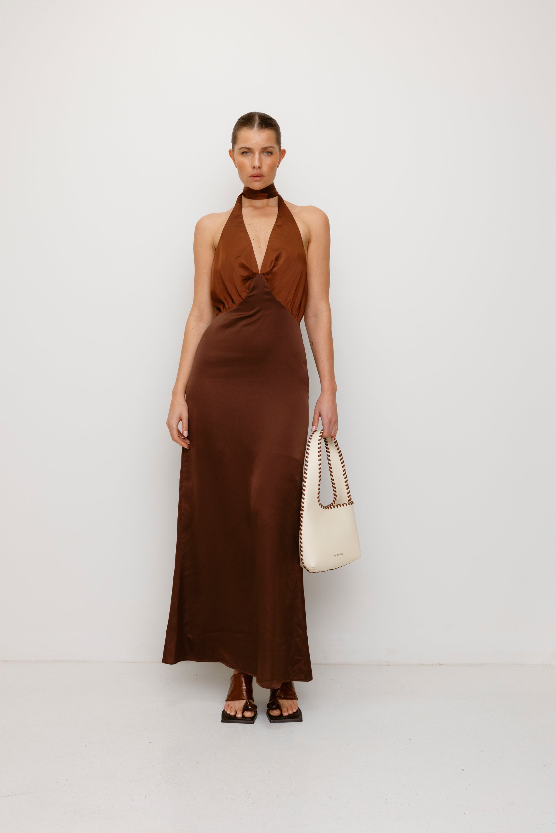 Women’s Cream Mara Shoulder Bag in 100 percent leather with twisted strap contrast binding and magnetic snap closure for everyday wear.