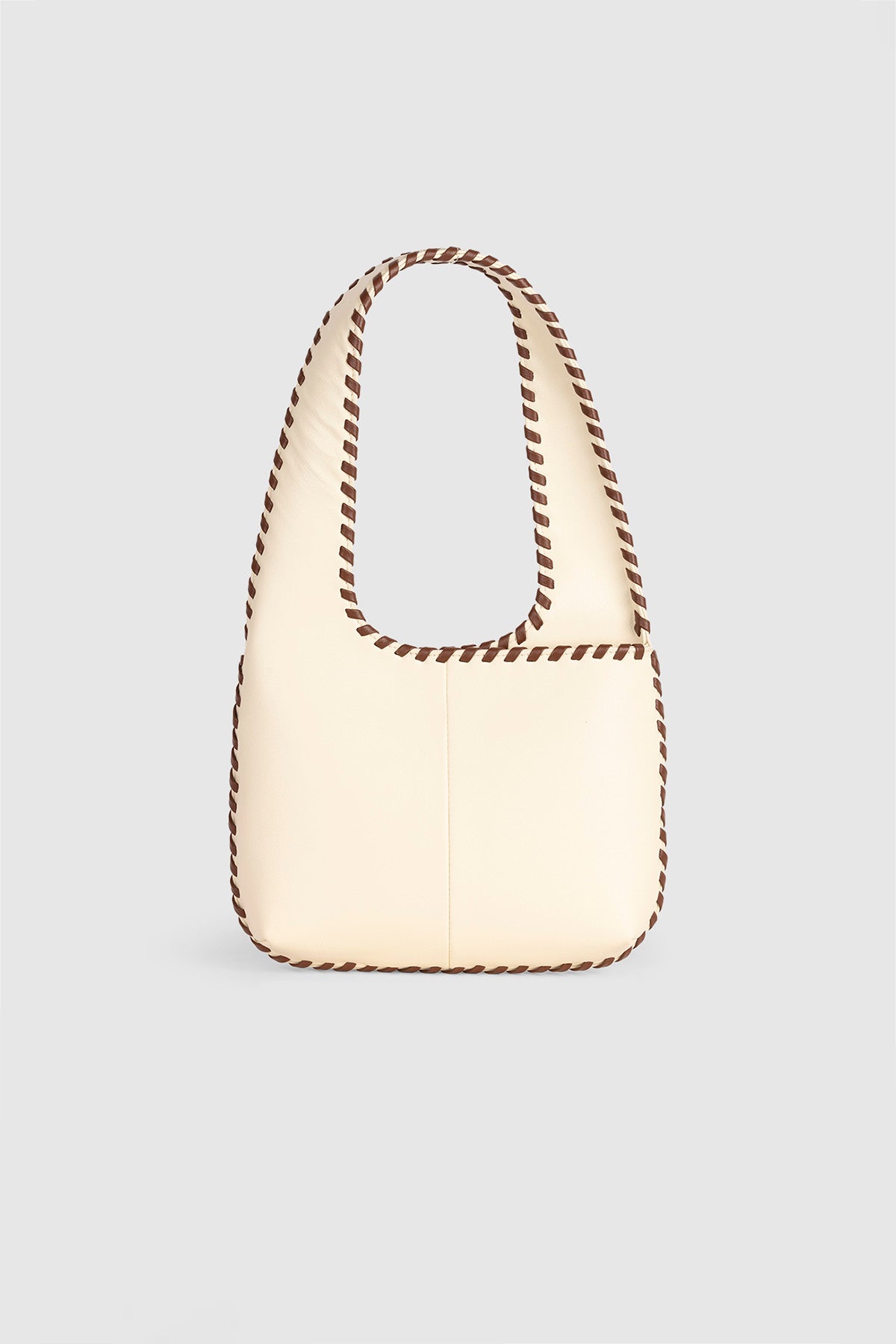 Women’s Cream Mara Shoulder Bag in 100 percent leather with twisted strap contrast binding and magnetic snap closure for everyday wear.