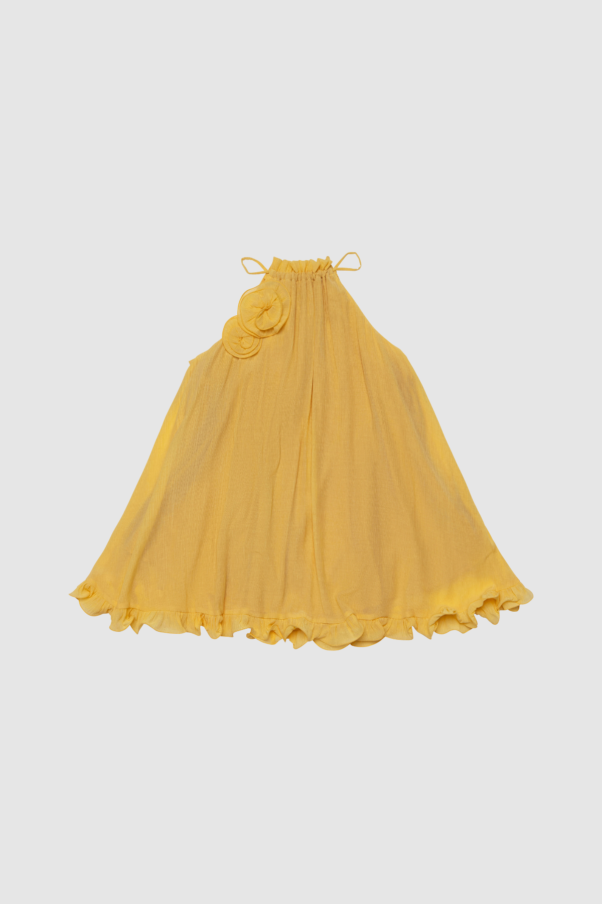 Flowy trapeze mini dress in butter, yellow, featuring rosette neckline detail, tie neck, frilled hem, and easy pull-on fit.