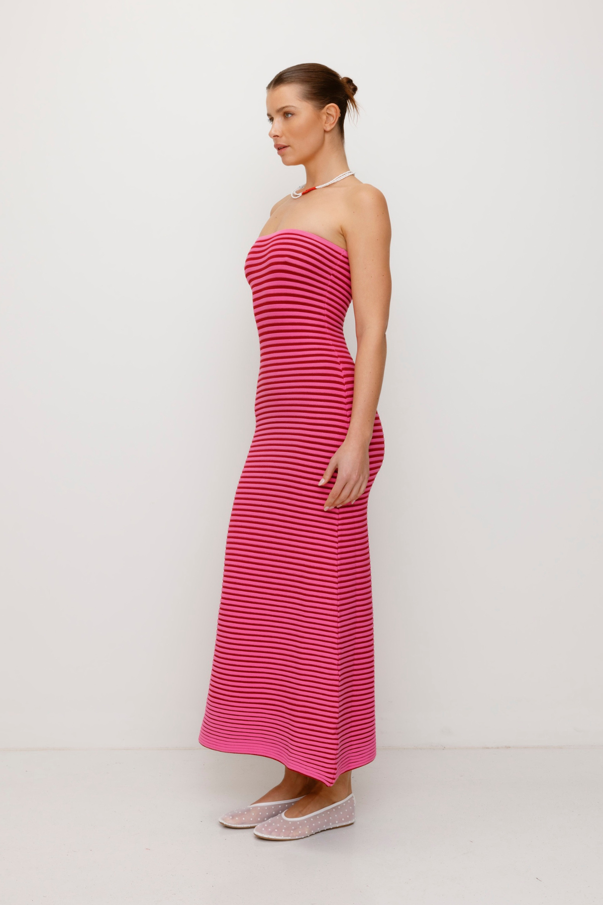 Pink strapless tonal stripe knit maxi dress with body-con fit, perfect for maternity or event wear.