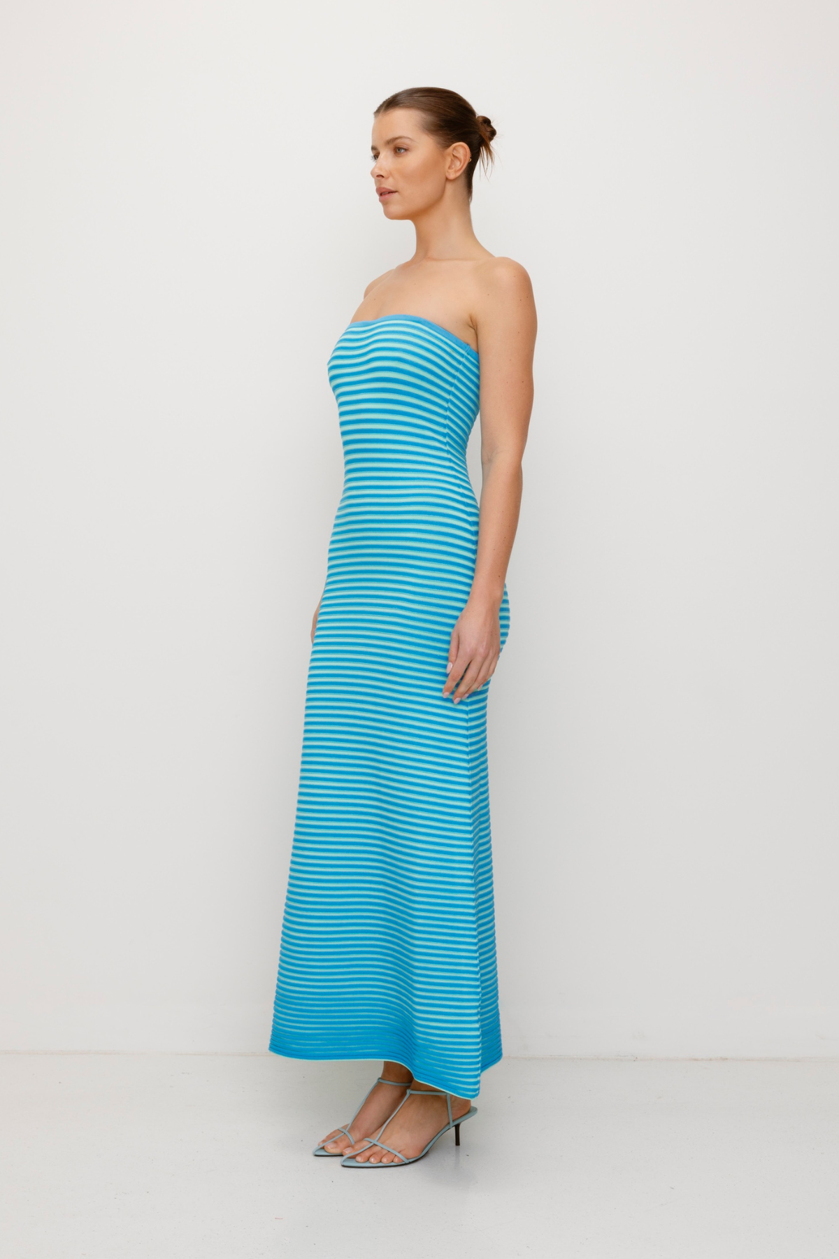 Blue strapless tonal stripe knit maxi dress with body-con fit, perfect for maternity or event wear.