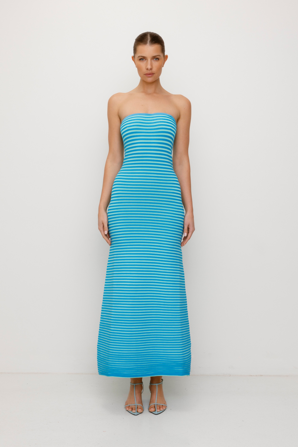 Blue strapless tonal stripe knit maxi dress with body-con fit, perfect for maternity or event wear.