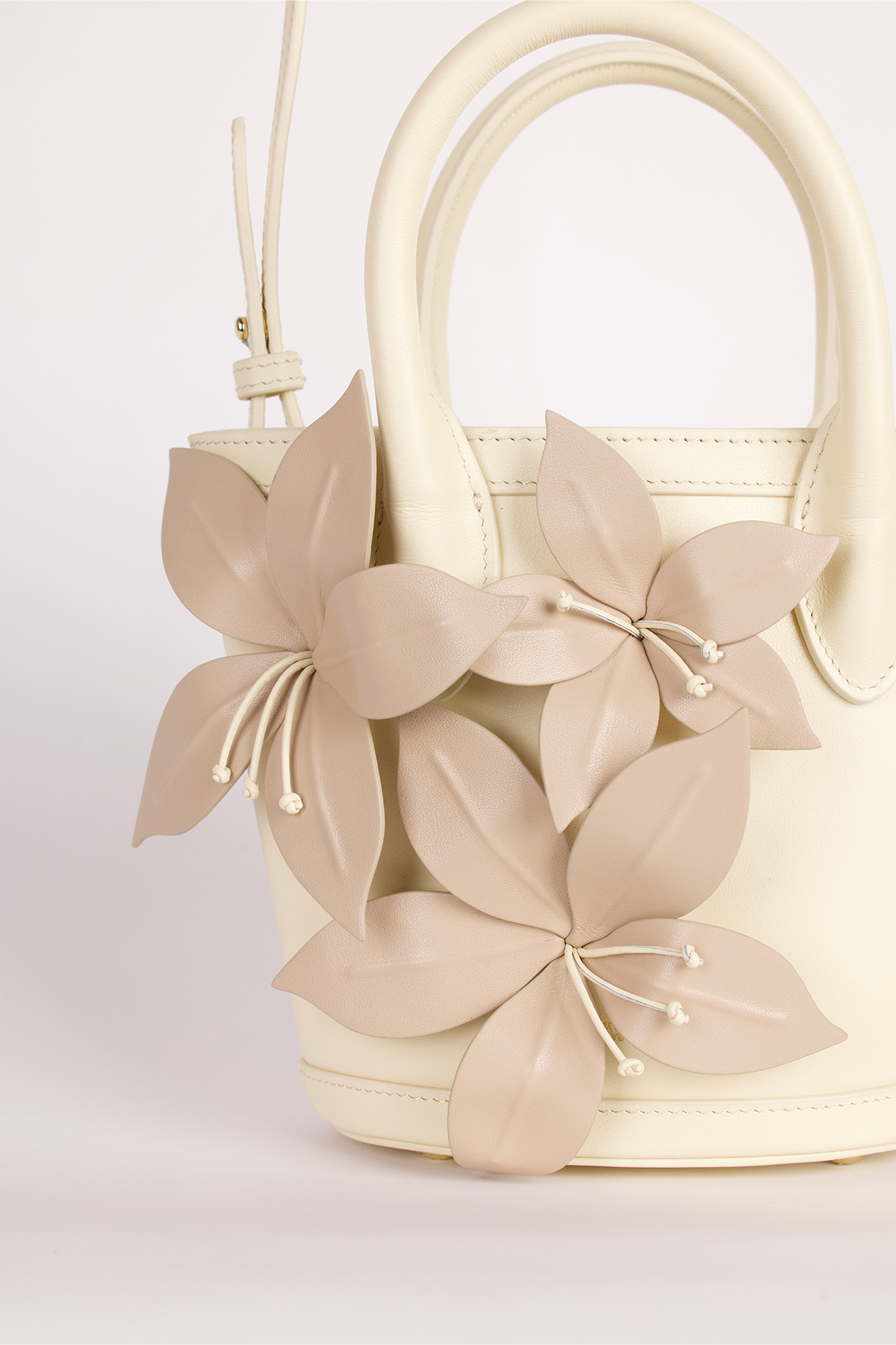 Womenās Cream La Monada Flower Bag in structured leather with floral embellishments dual top handles and crossbody option for day to night wear