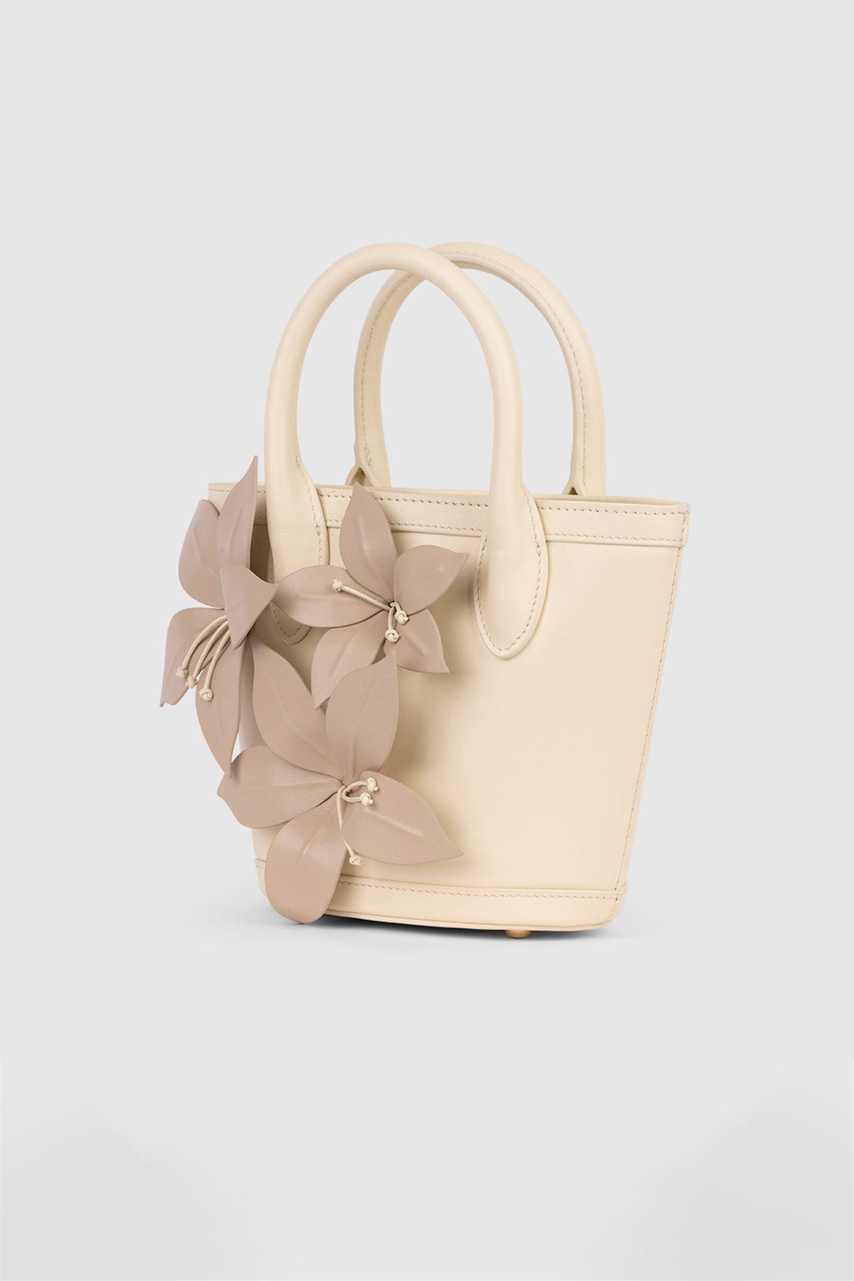 Womenās Cream La Monada Flower Bag in structured leather with floral embellishments dual top handles and crossbody option for day to night wear