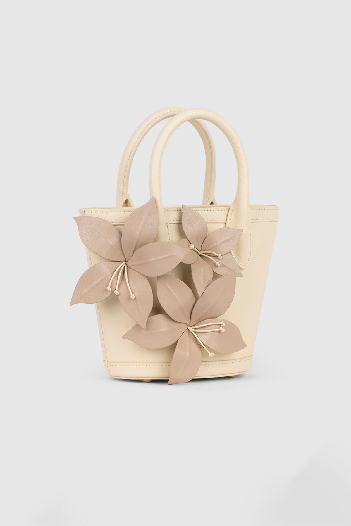 Womenās Cream La Monada Flower Bag in structured leather with floral embellishments dual top handles and crossbody option for day to night wear
