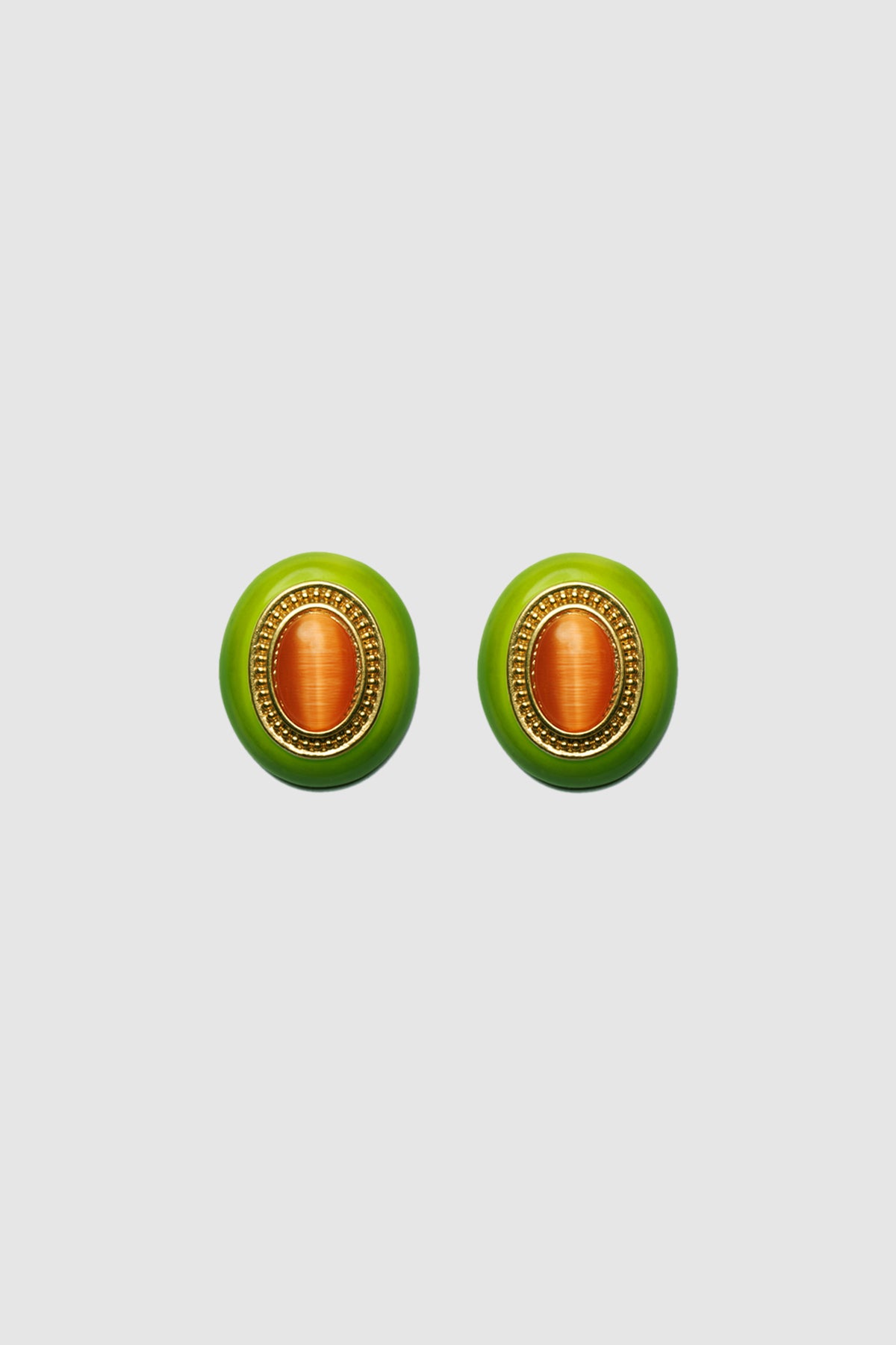 Women’s oval green statement earrings made from silver with a polished finish, a bold accessory for day or evening wear.