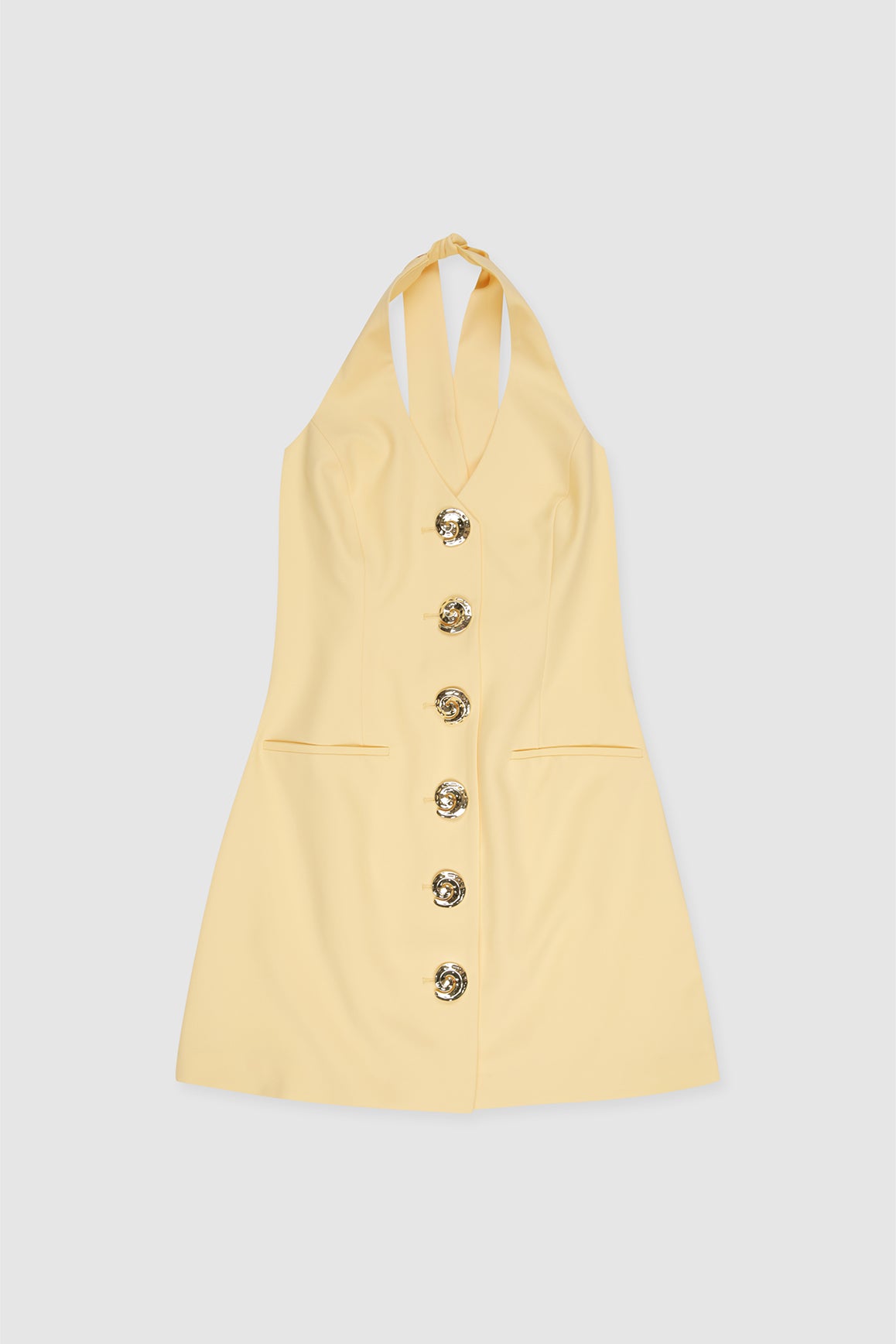 Best-selling women’s Butter Yellow Irida mini halter neck vest dress with gold swirl buttons, tie-back, and front welt pocket—wear alone or with matching pants.