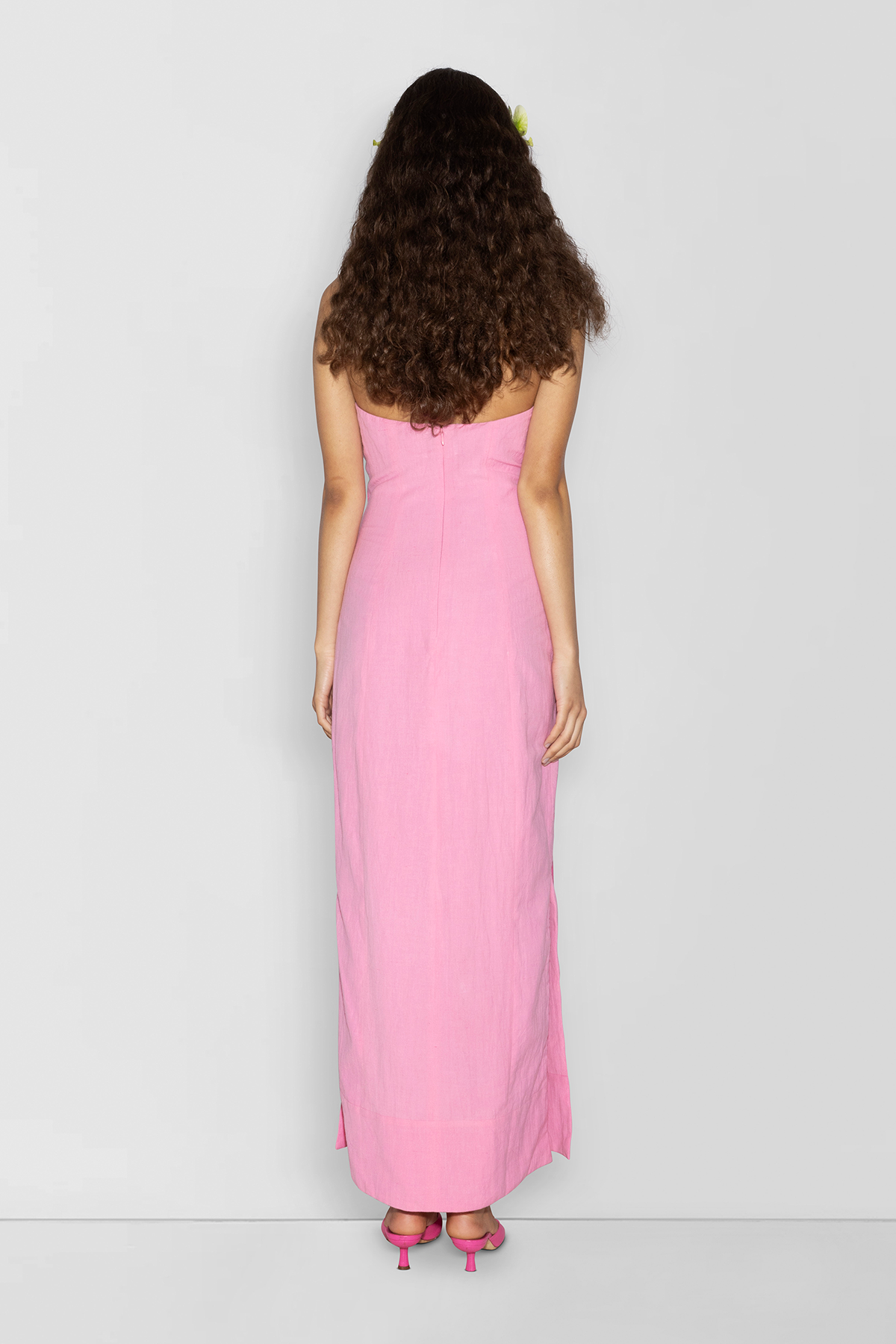 Woman wearing Pink linen cotton maxi dress with contrast embroidery and shaped bust.