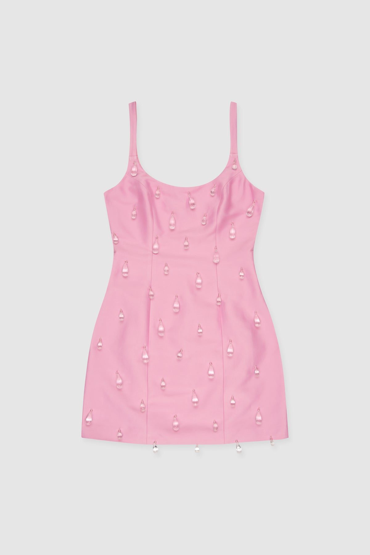 Woman wearing Pink beaded mini dress with satin finish and teardrop embellishments.