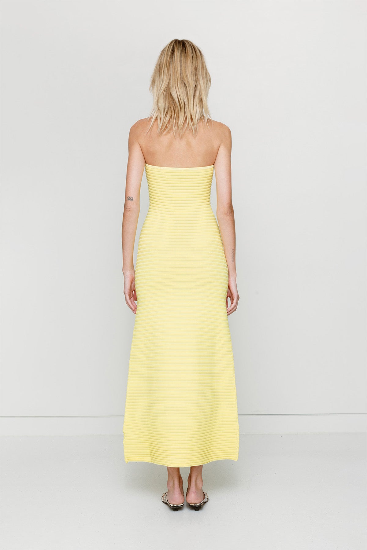 Yellow strapless tonal stripe knit maxi dress with body-con fit, perfect for maternity or event wear.