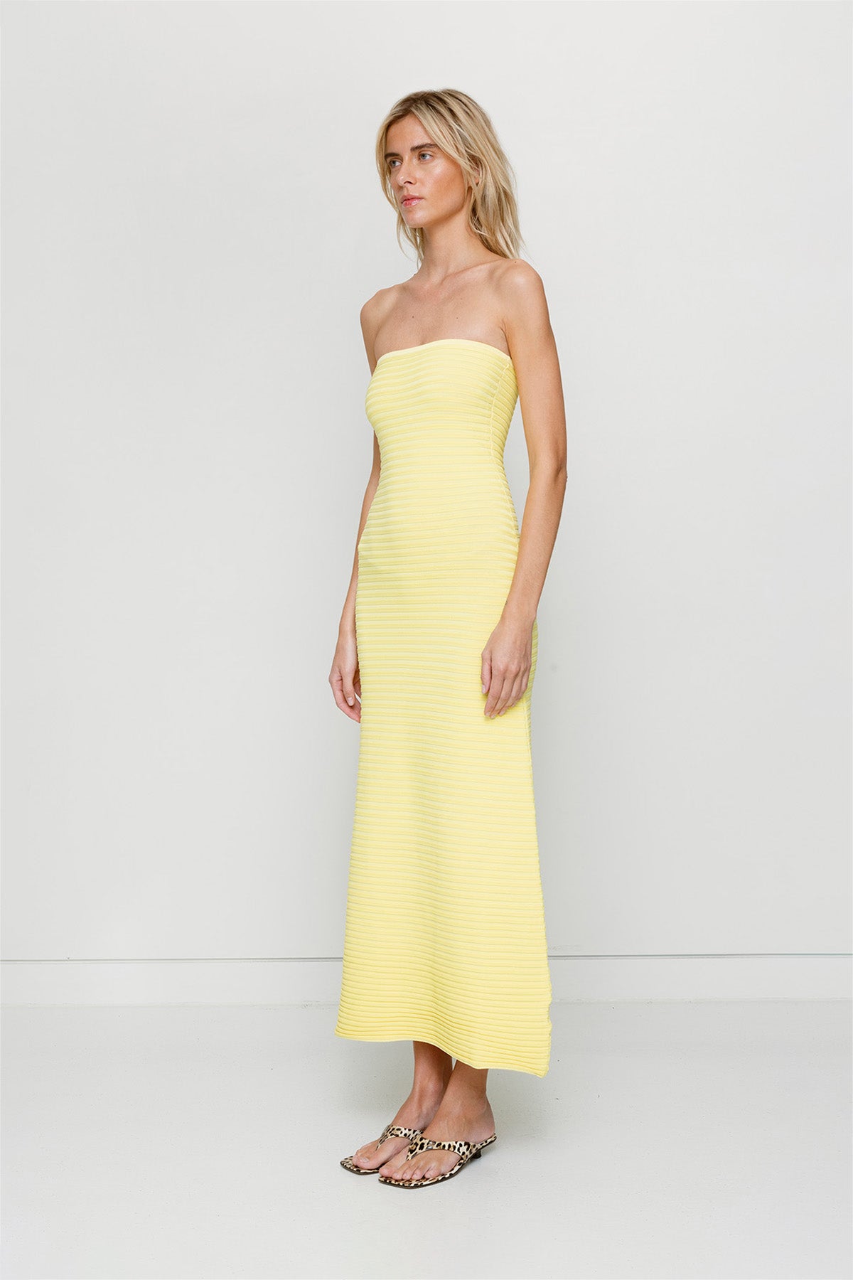 Yellow strapless tonal stripe knit maxi dress with body-con fit, perfect for maternity or event wear.