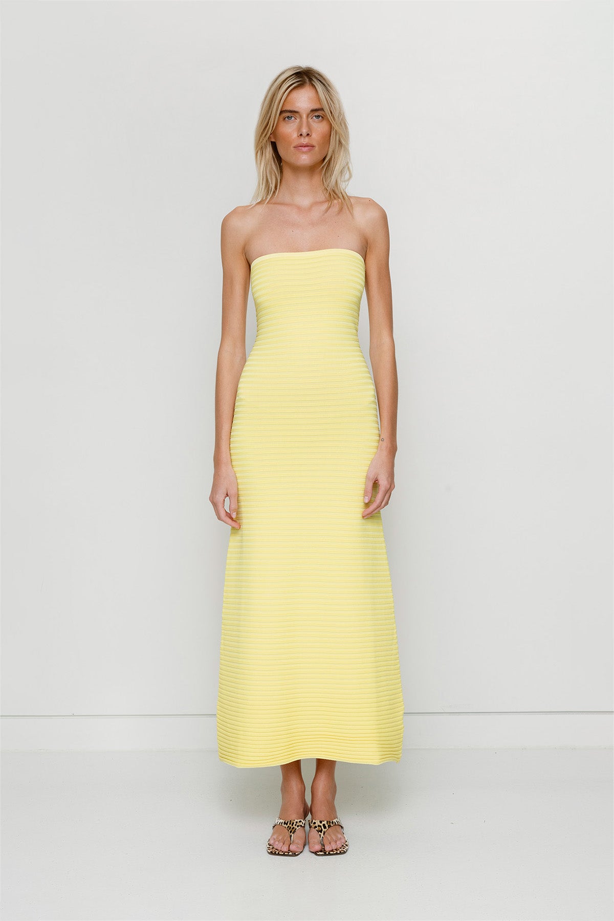 Yellow strapless tonal stripe knit maxi dress with body-con fit, perfect for maternity or event wear.