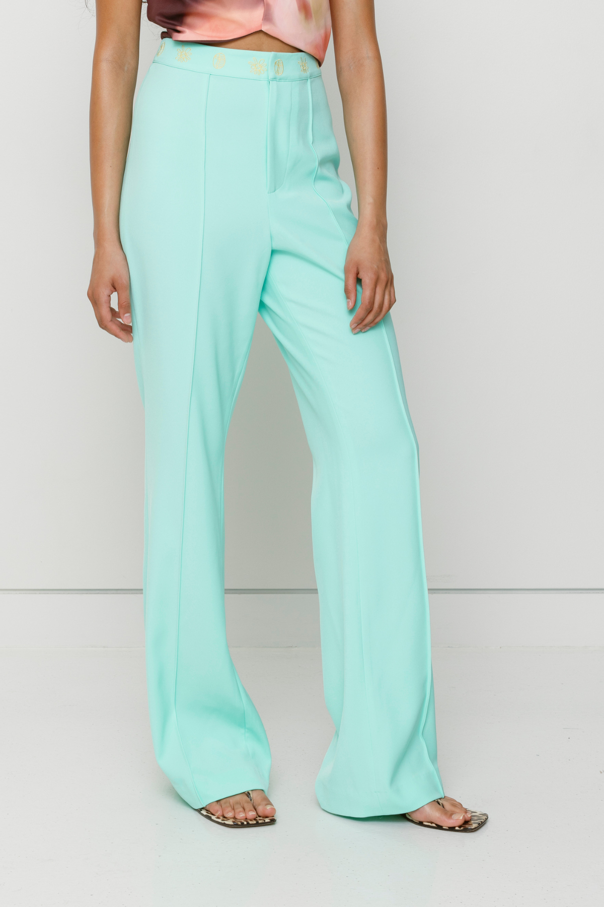 Tailored flared Inka pants with pintuck detail and custom waistband embroidery by The Wolf Gang, styled for a coordinated outfit with Inka Mini Dress.