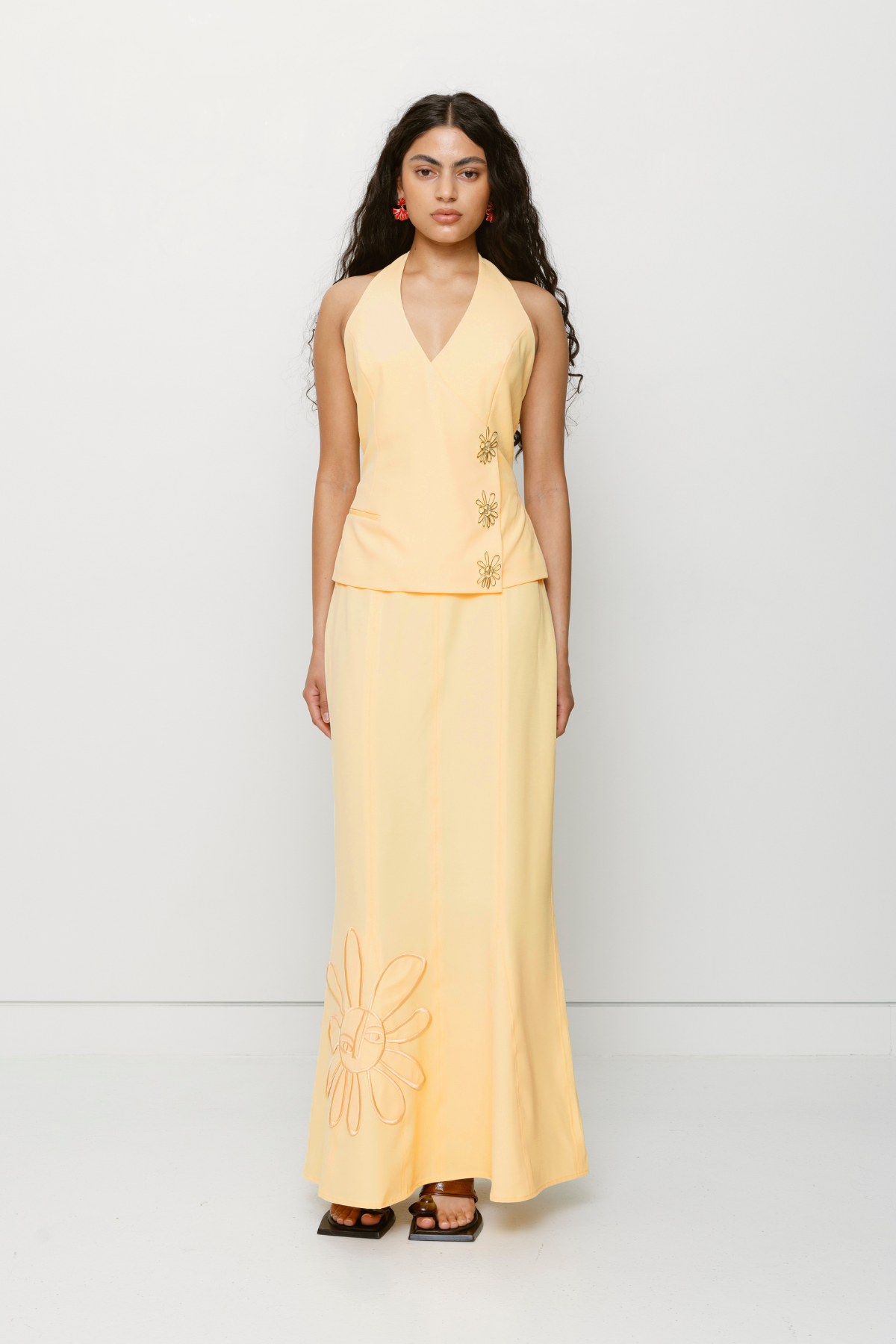 Halterneck vest top in butter yellow or charcoal grey with asymmetric closure and custom hardware by The Wolf Gang, styled with jeans or matching skirt.