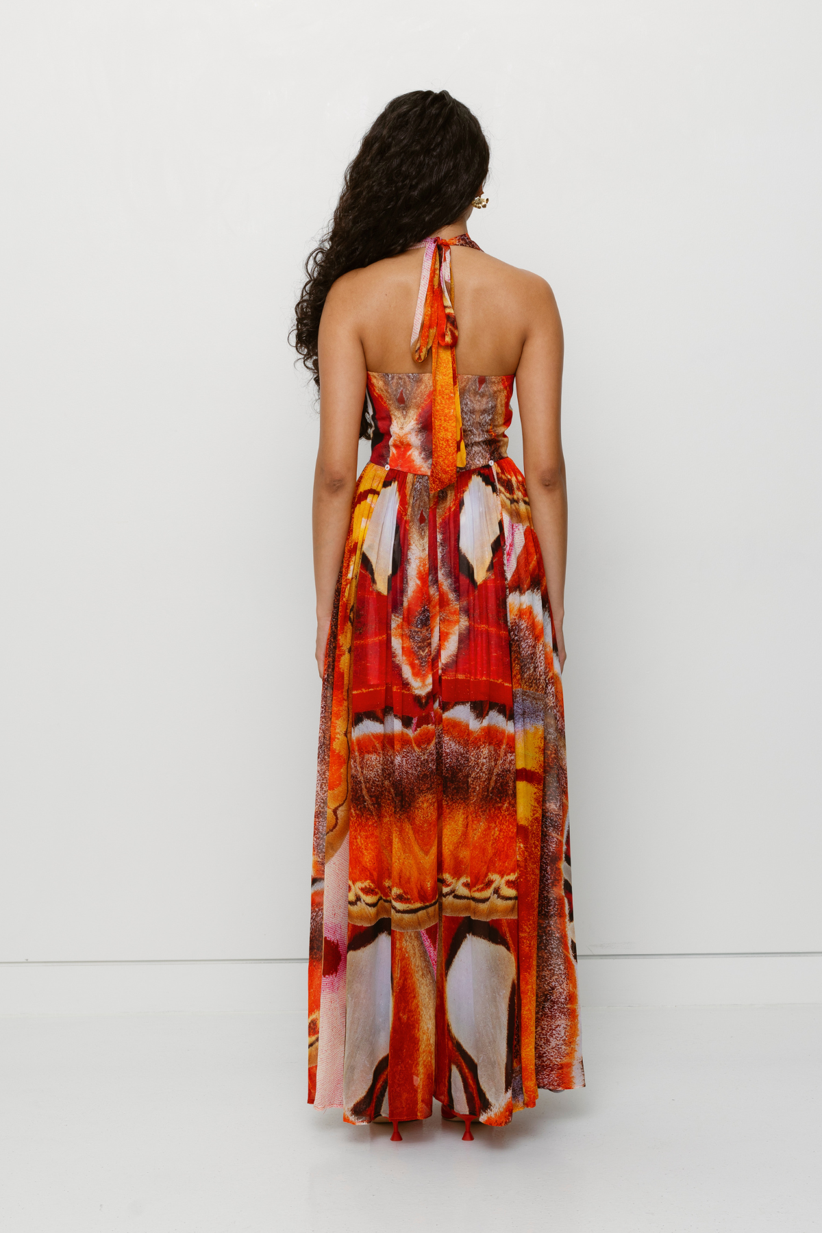 Versatile sheer Rumi Maxi Dress with adjustable skirt buttons by The Wolf Gang, customizable length for day or night wear.